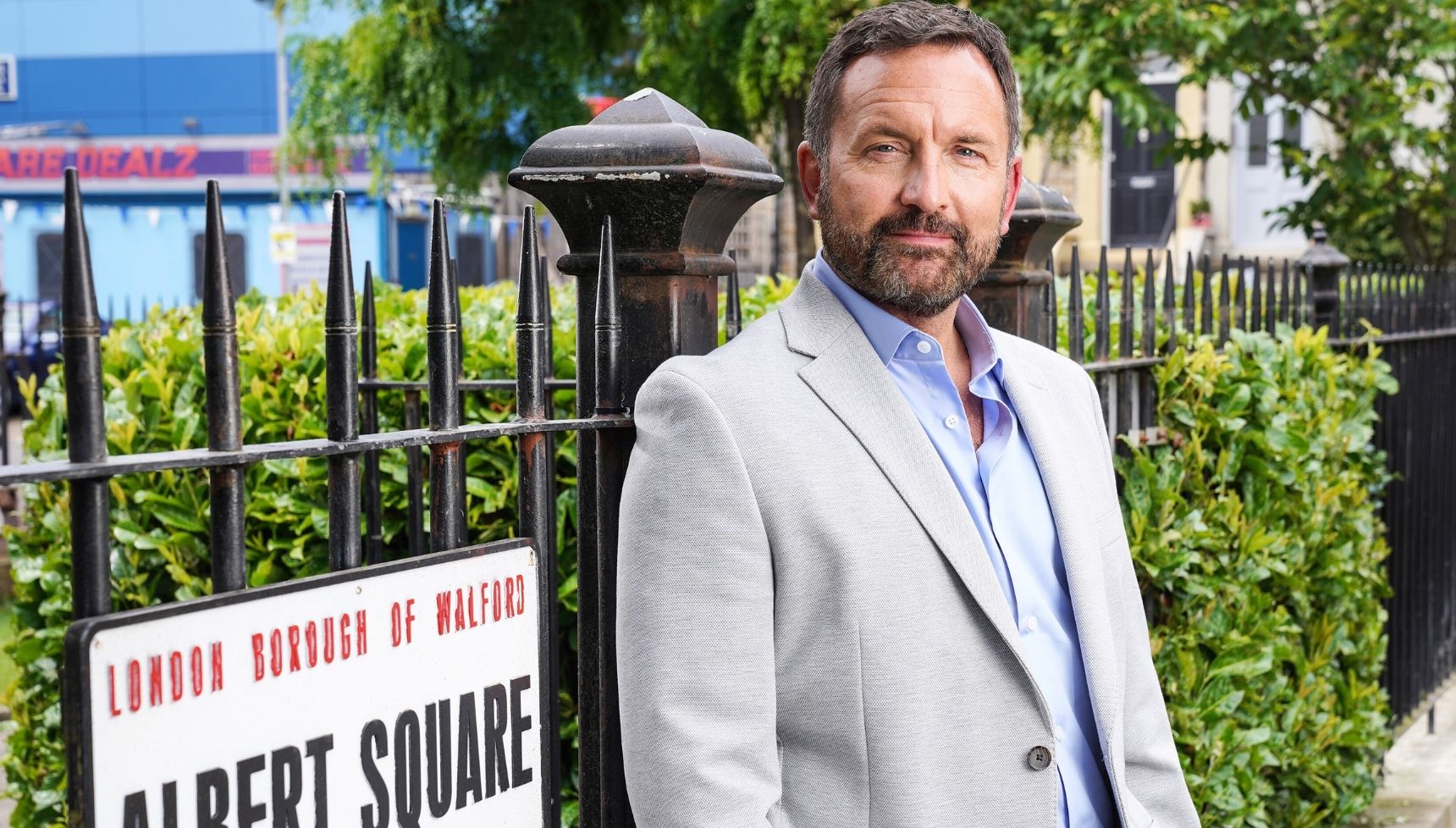Jake by the Albert Square sign when he returned in 2024 - EastEnders Jake Moon return