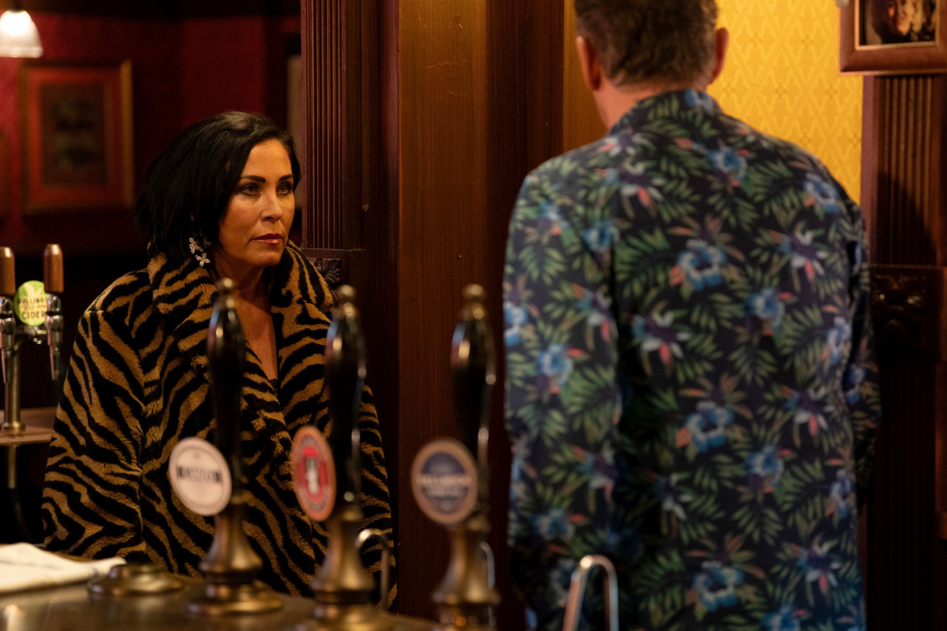 Kat and Alfie looking serious behind the bar
