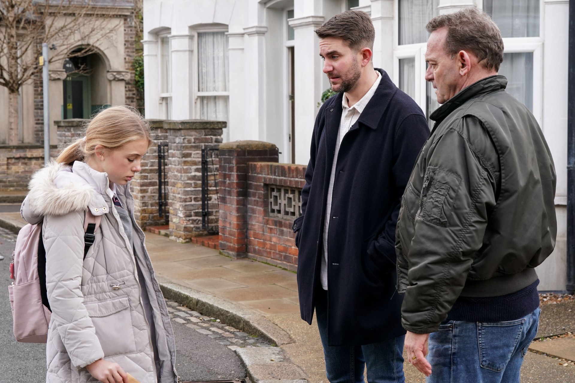 Lexi looks upset while Billy and Callum chat with her in the Square in EastEnders spoilers