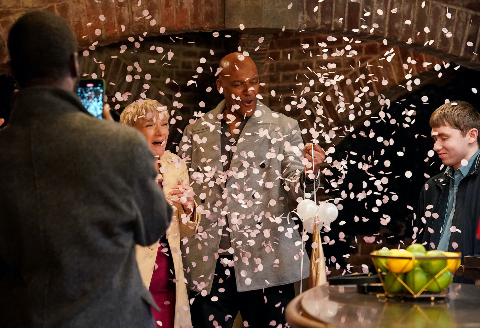 George and Nicola hold a gender reveal party as pink confetti falls around them