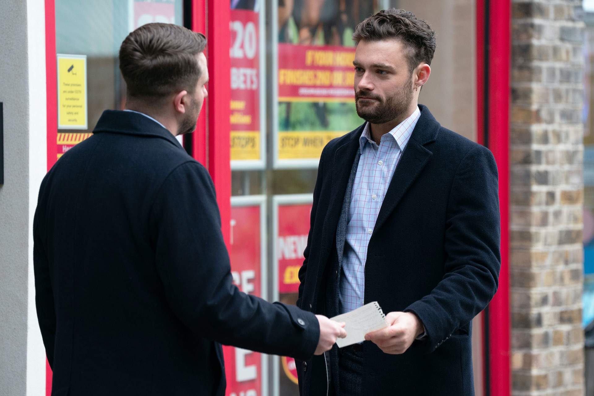 Callum and Johnny in the street looking tense 