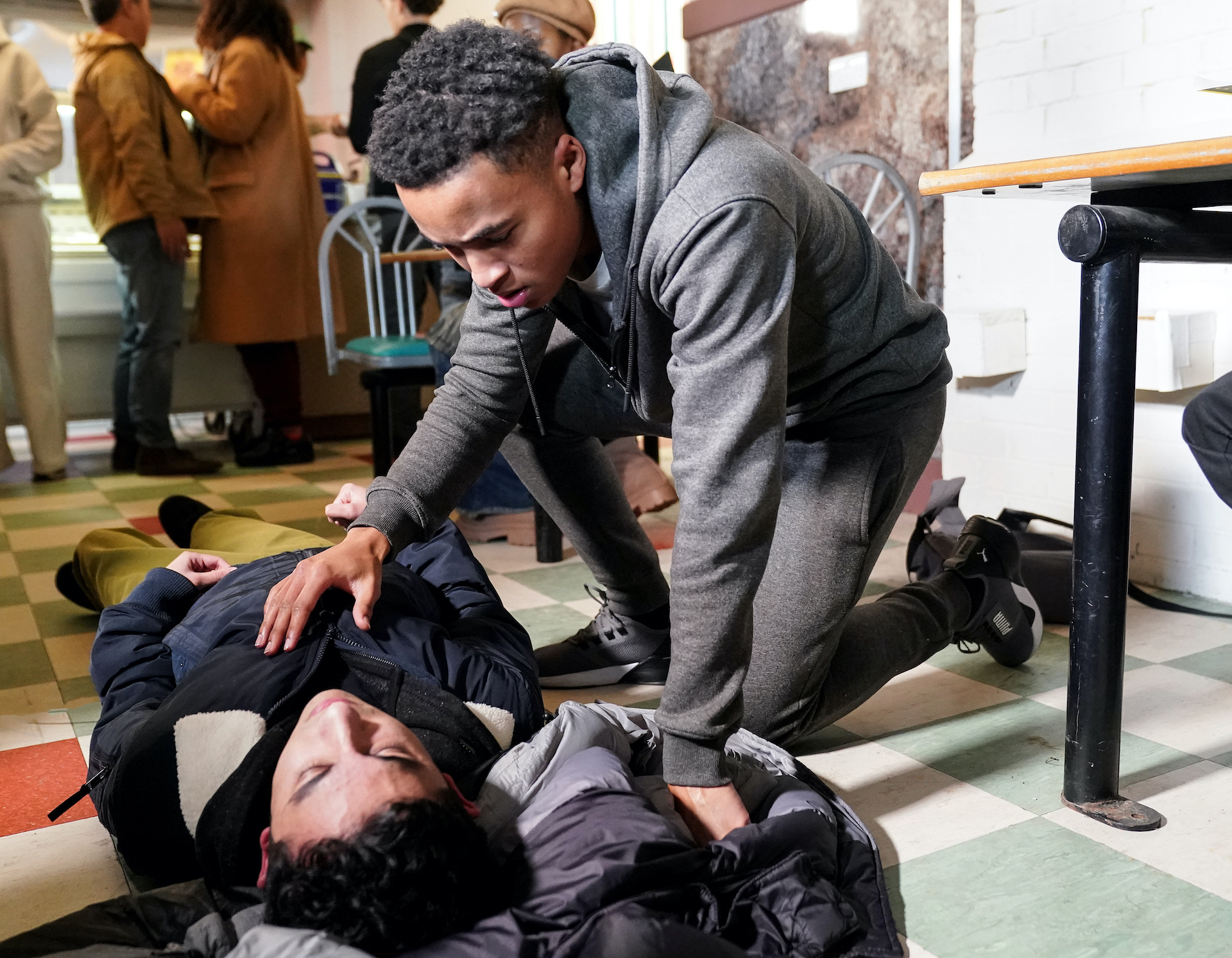 Denzel looking after Nugget who is lying on the floor