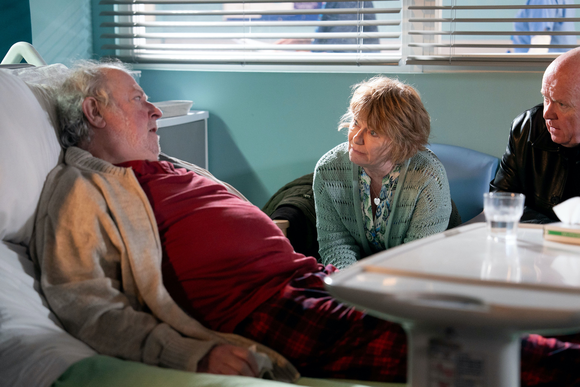 Julie and Phil tell Nigel about his care home place as he lies in a hospital bed 