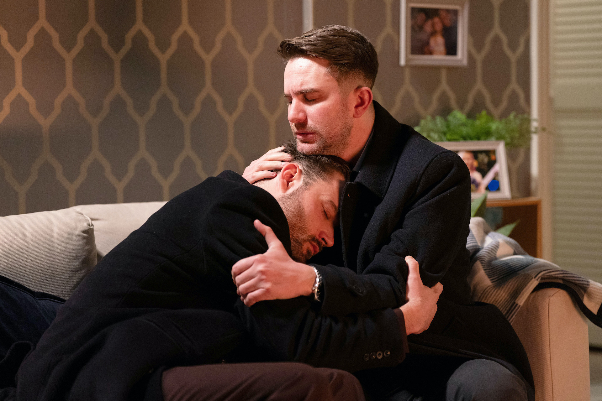 Johnny and Callum hugging and looking sad 