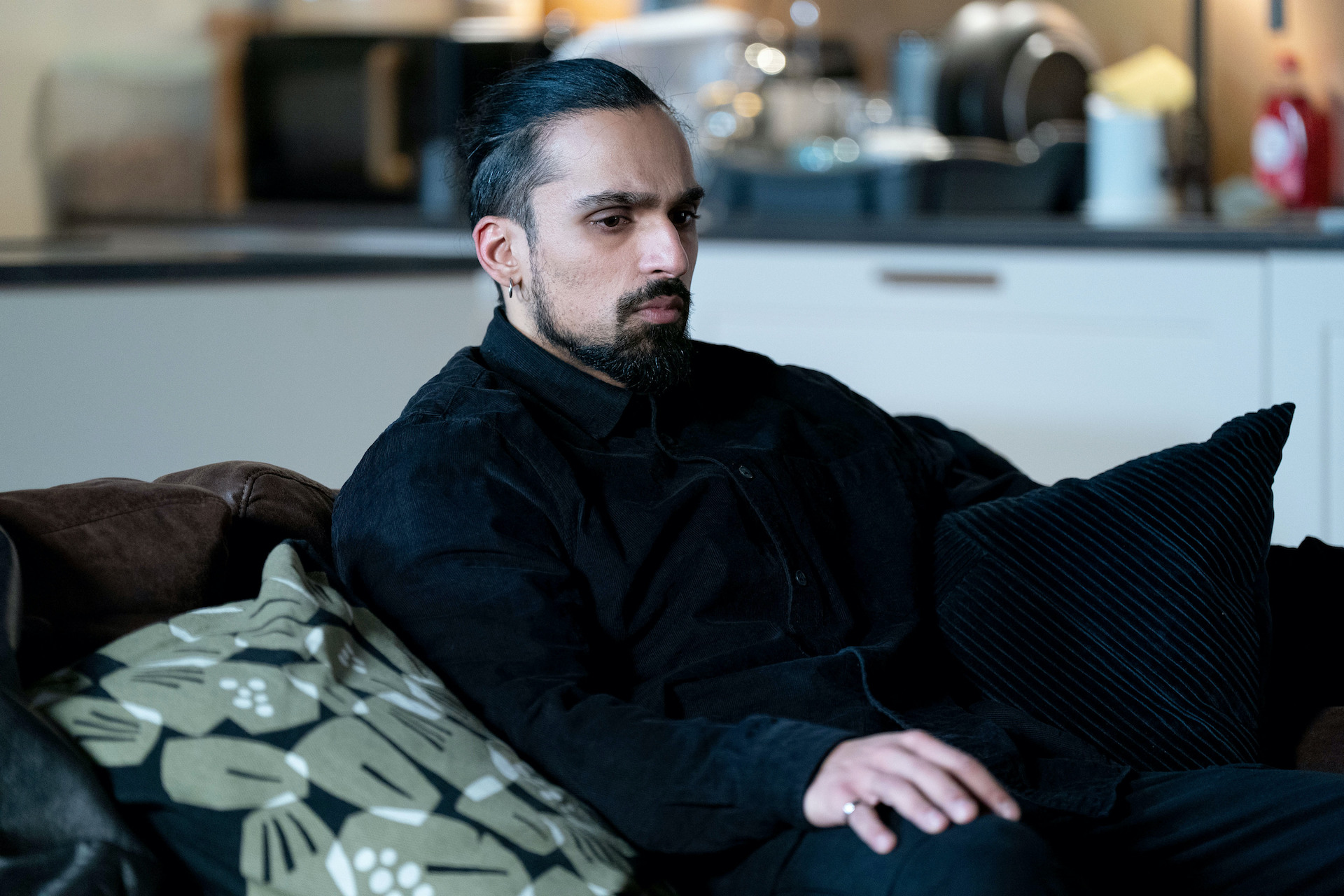 Ravi looking down in his lounge