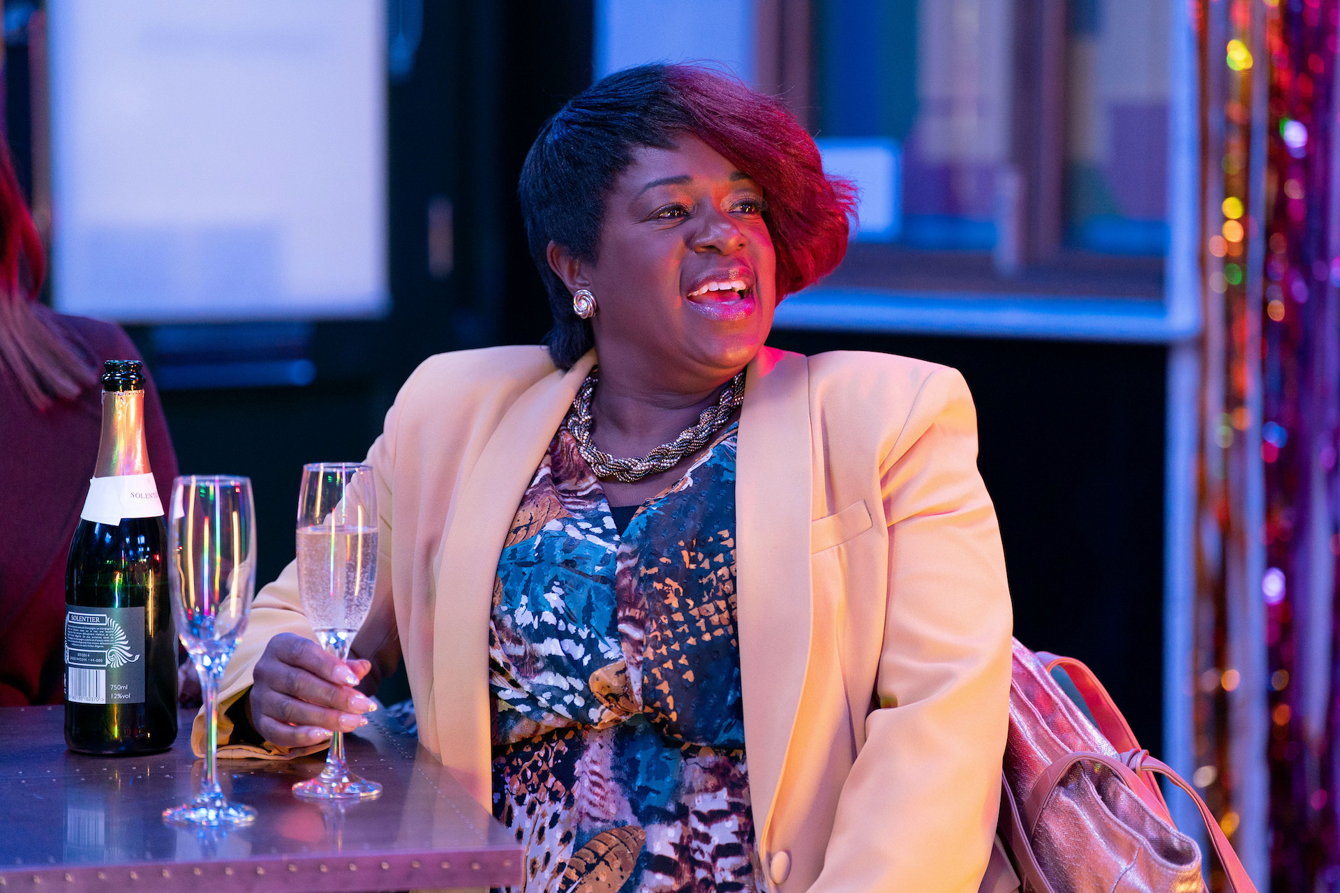 Kim smiling and drinking champagne 