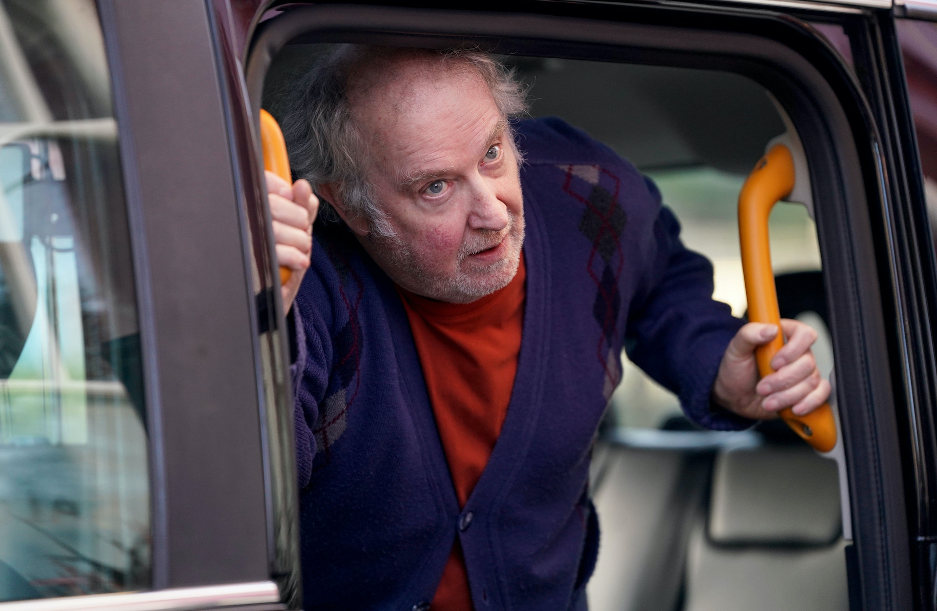 Nigel gets out of a taxi 