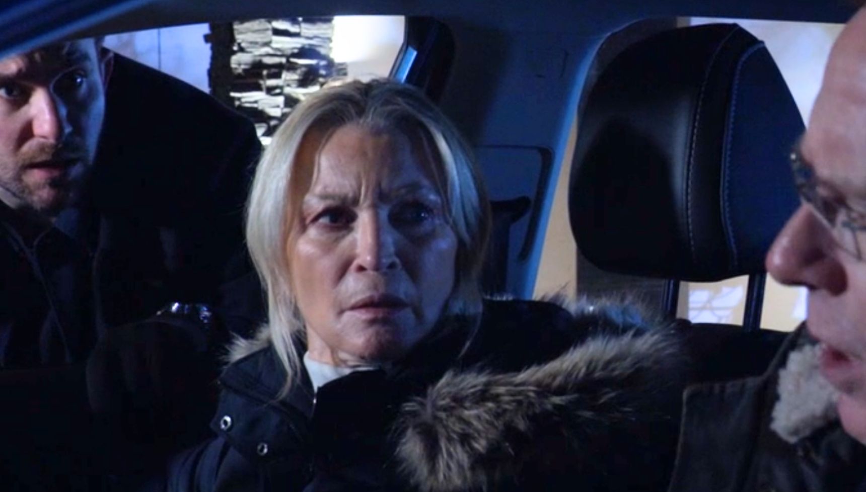 Callum, Ian and Kathy in a car at night outside a house belonging to Tim in EastEnders
