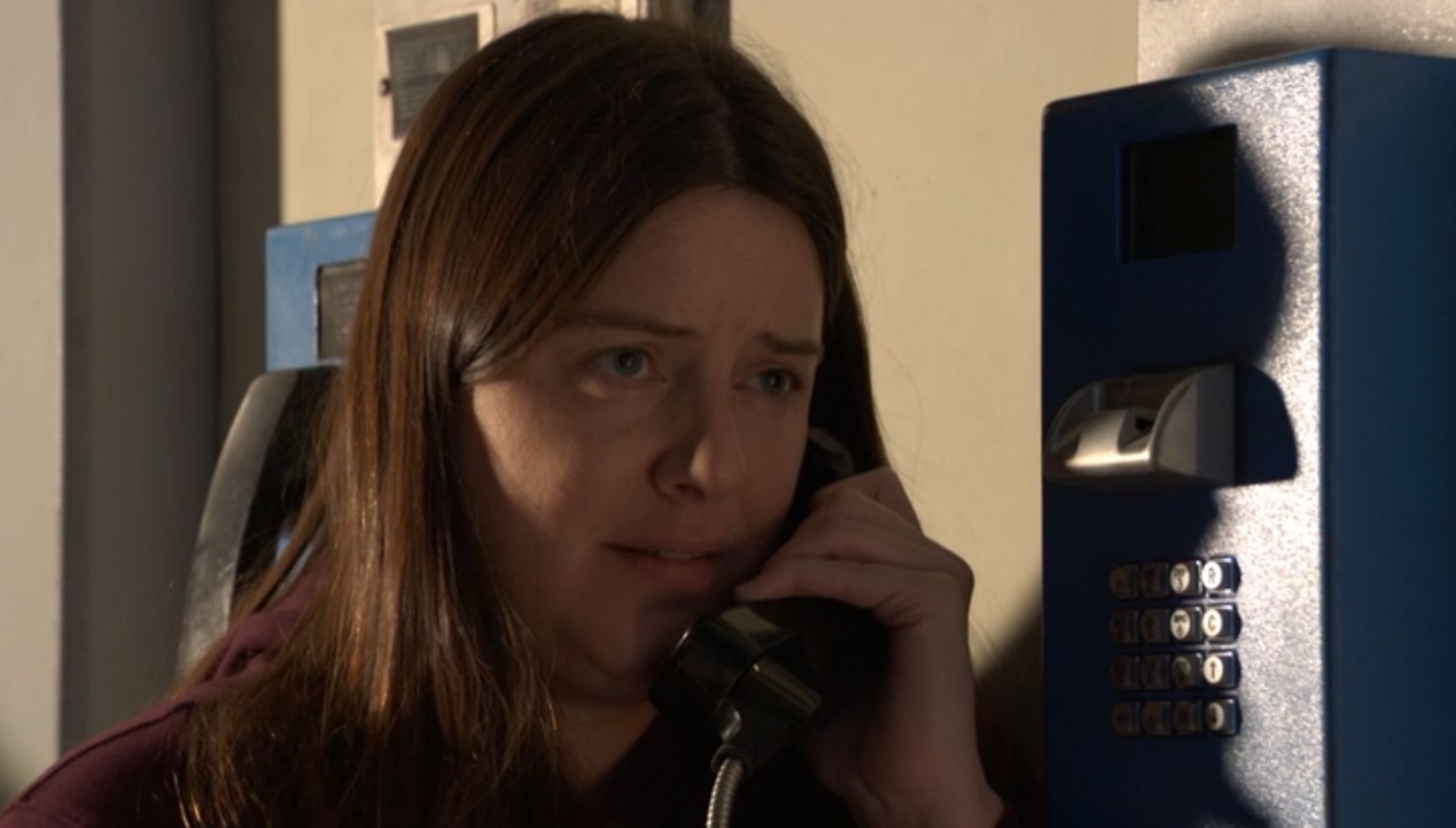 Zoe making a phone call from prison