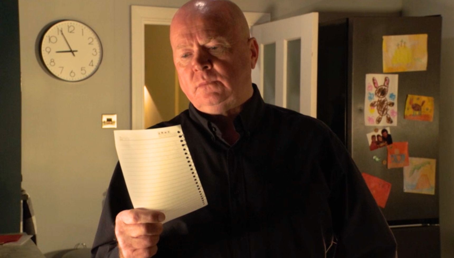Phil reading a piece of paper 