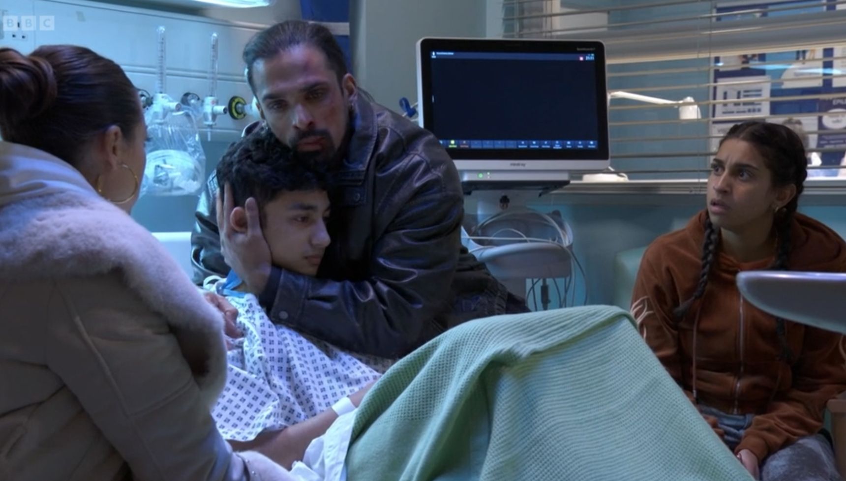 Ravi holds Nugget as he sits in a hospital bed in EastEnders Ravi self-harm storyline