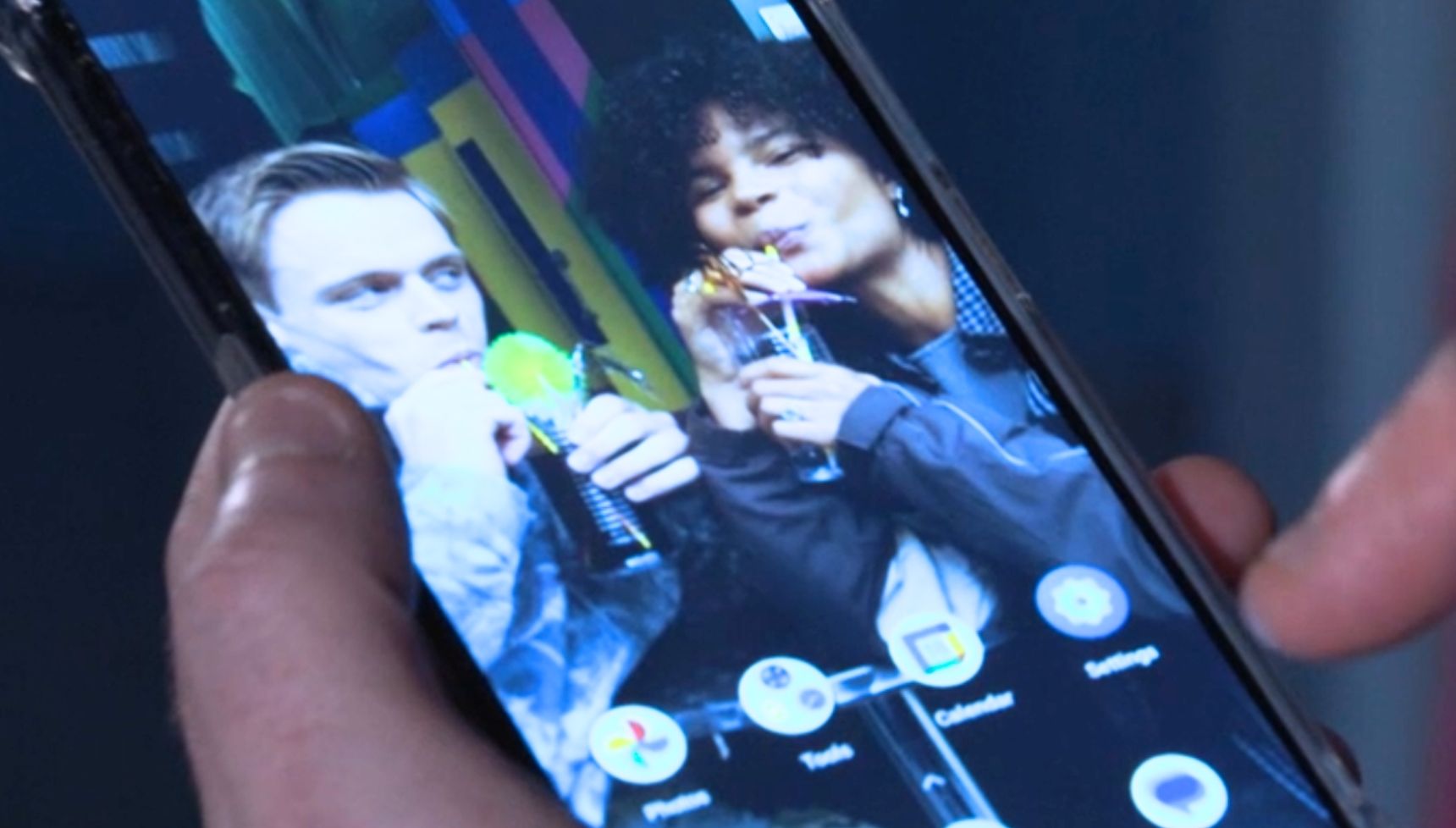 a close up of Jasmine's phone in Max's hand