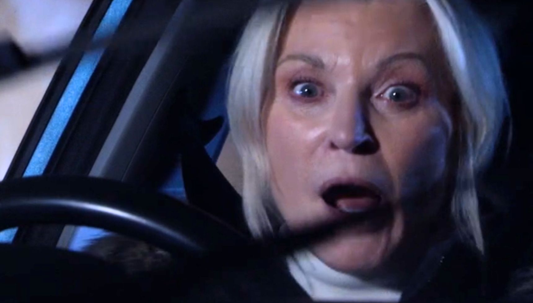 Kathy looking scared as she drives the car away fast