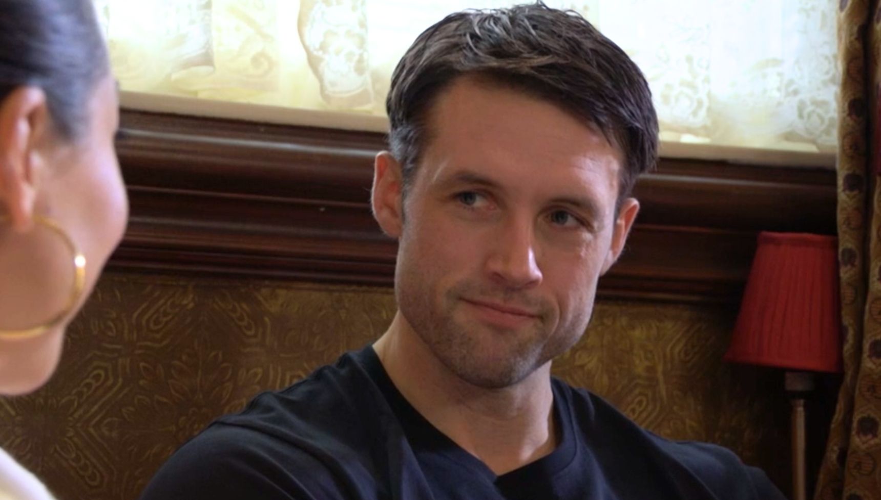 Mark smiling at Priya