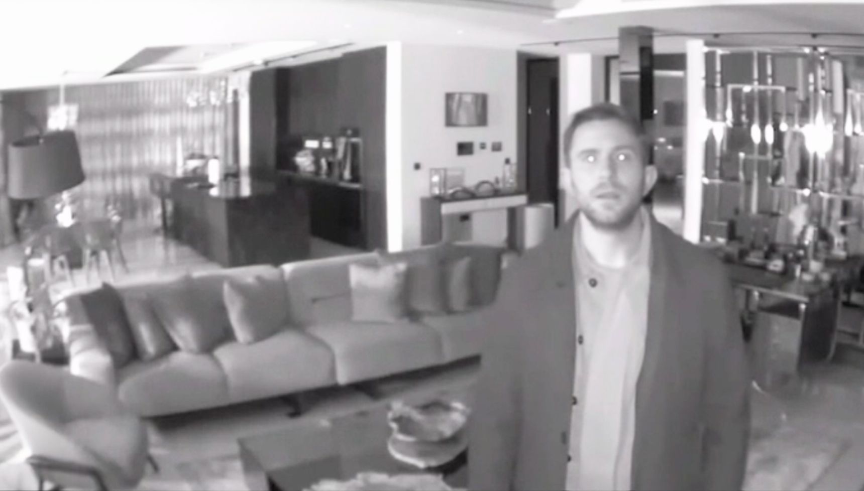 Black and white CCTV footage of Callum in Tim's house 