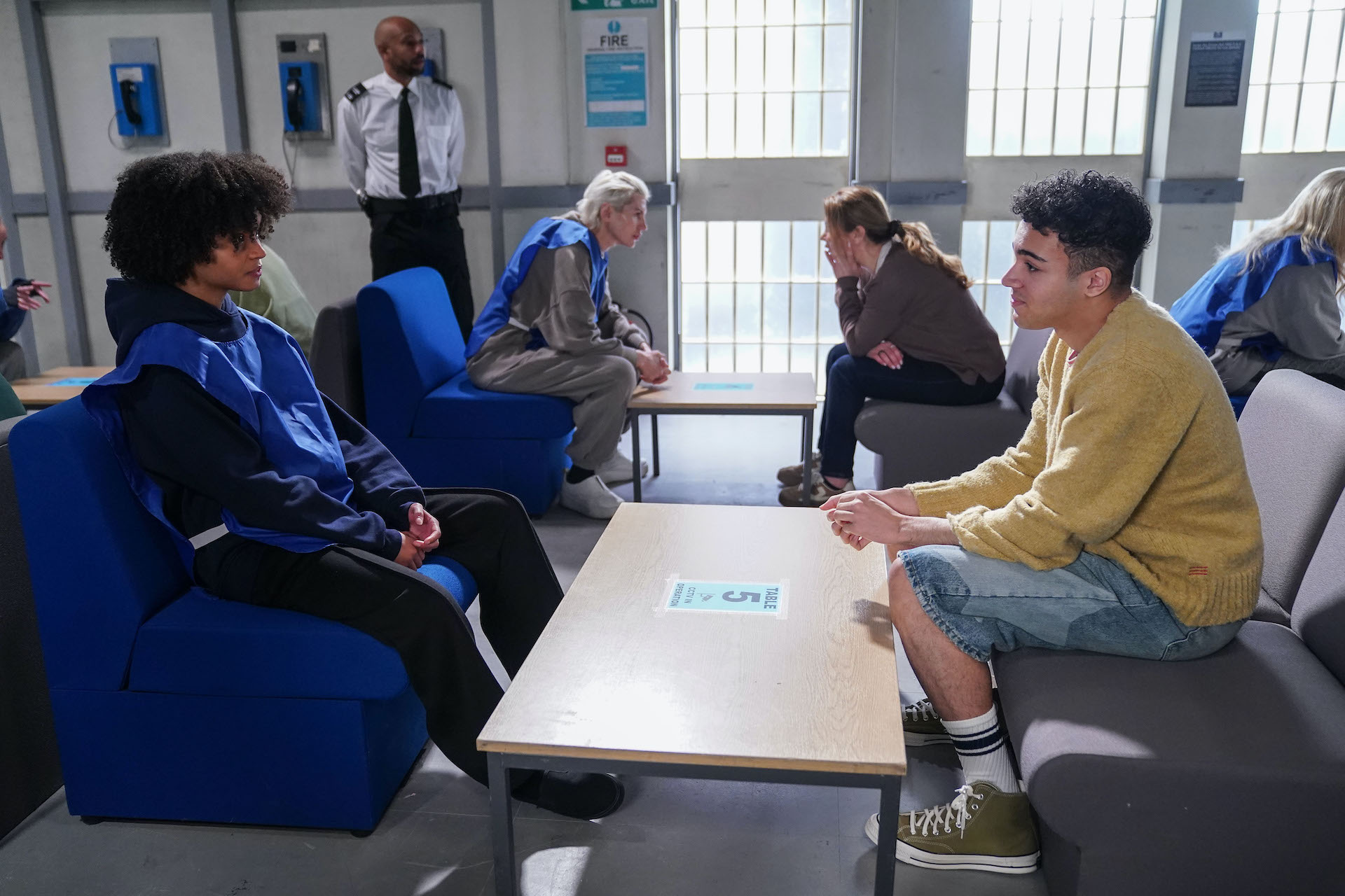 Jasmine and Josh talking in the prison visiting area 