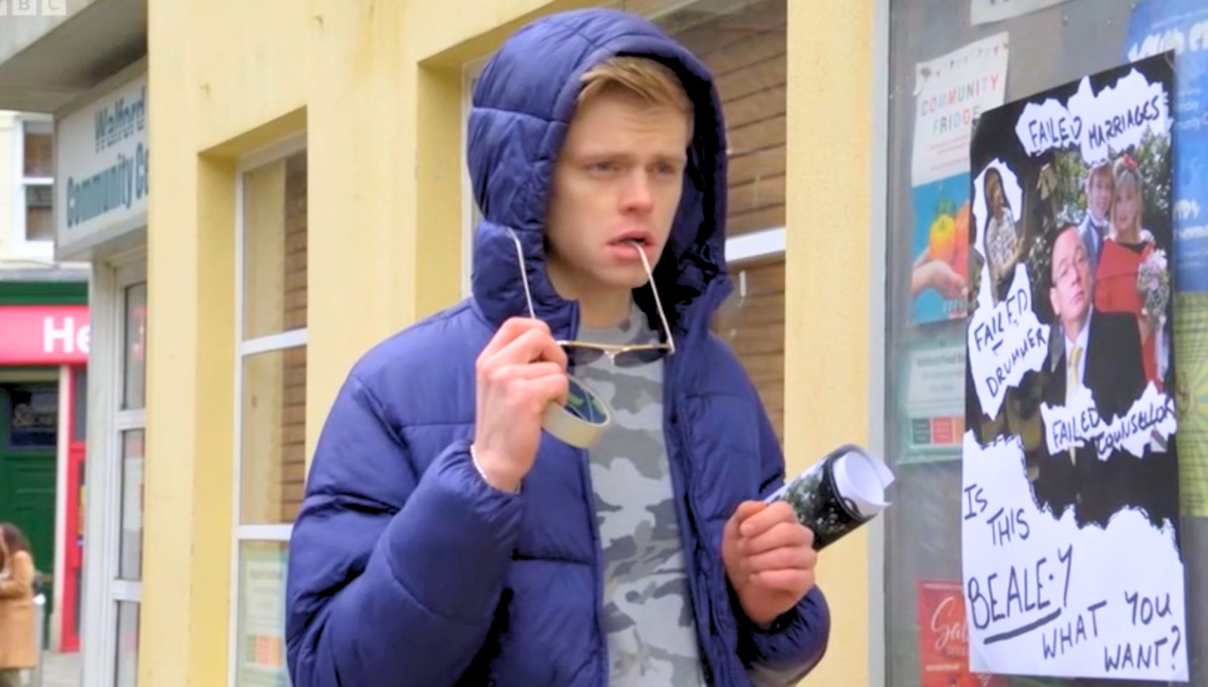Oscar in a blue coat with his hood up and sunglasses