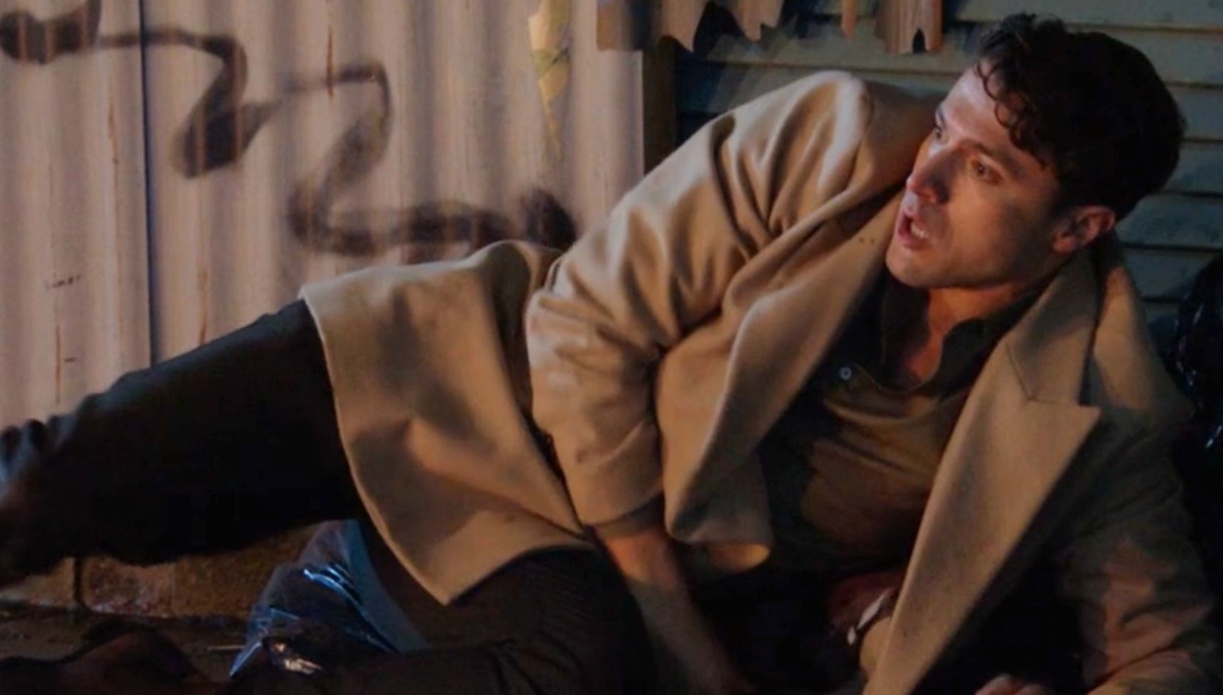 Tim lying on the floor looking terrified in EastEnders 