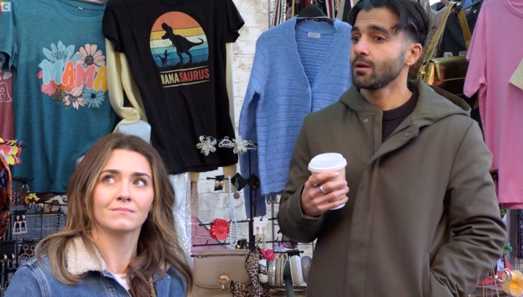 Penny and Vinny in the market talking to Suki in EastEnders 