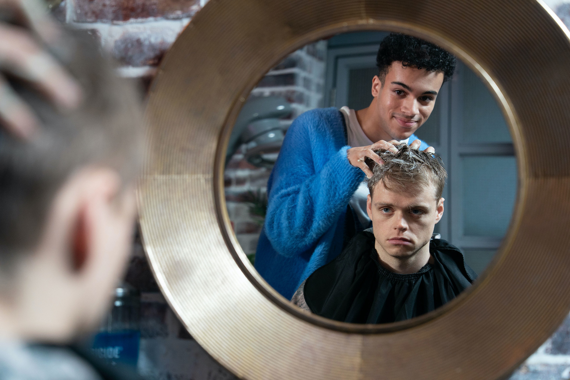 Josh doing Oscar's hair and looking at him in the mirror