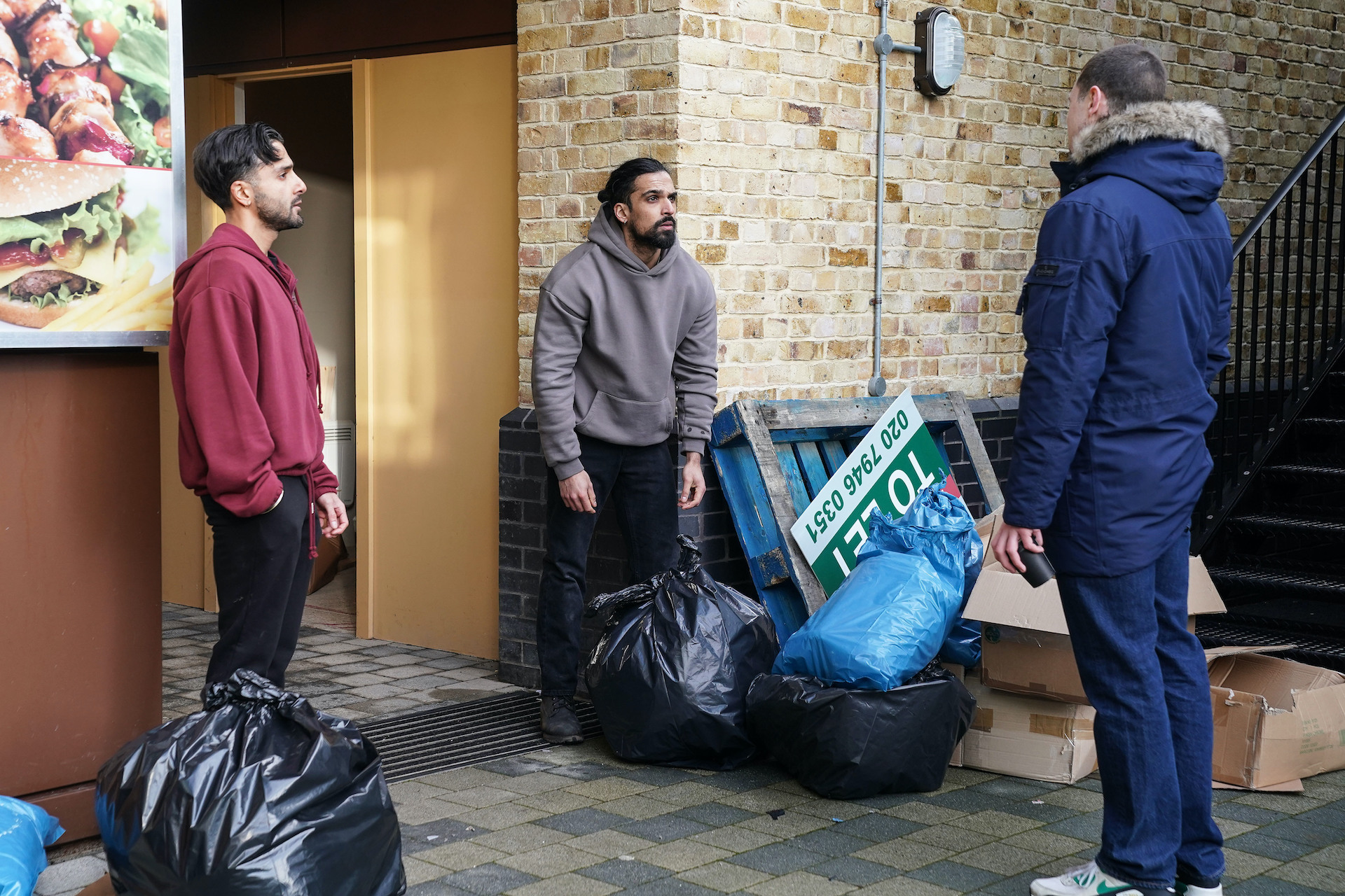 Harry laughing at Ravi as he throws out bin bags in EastEnders spoilers 