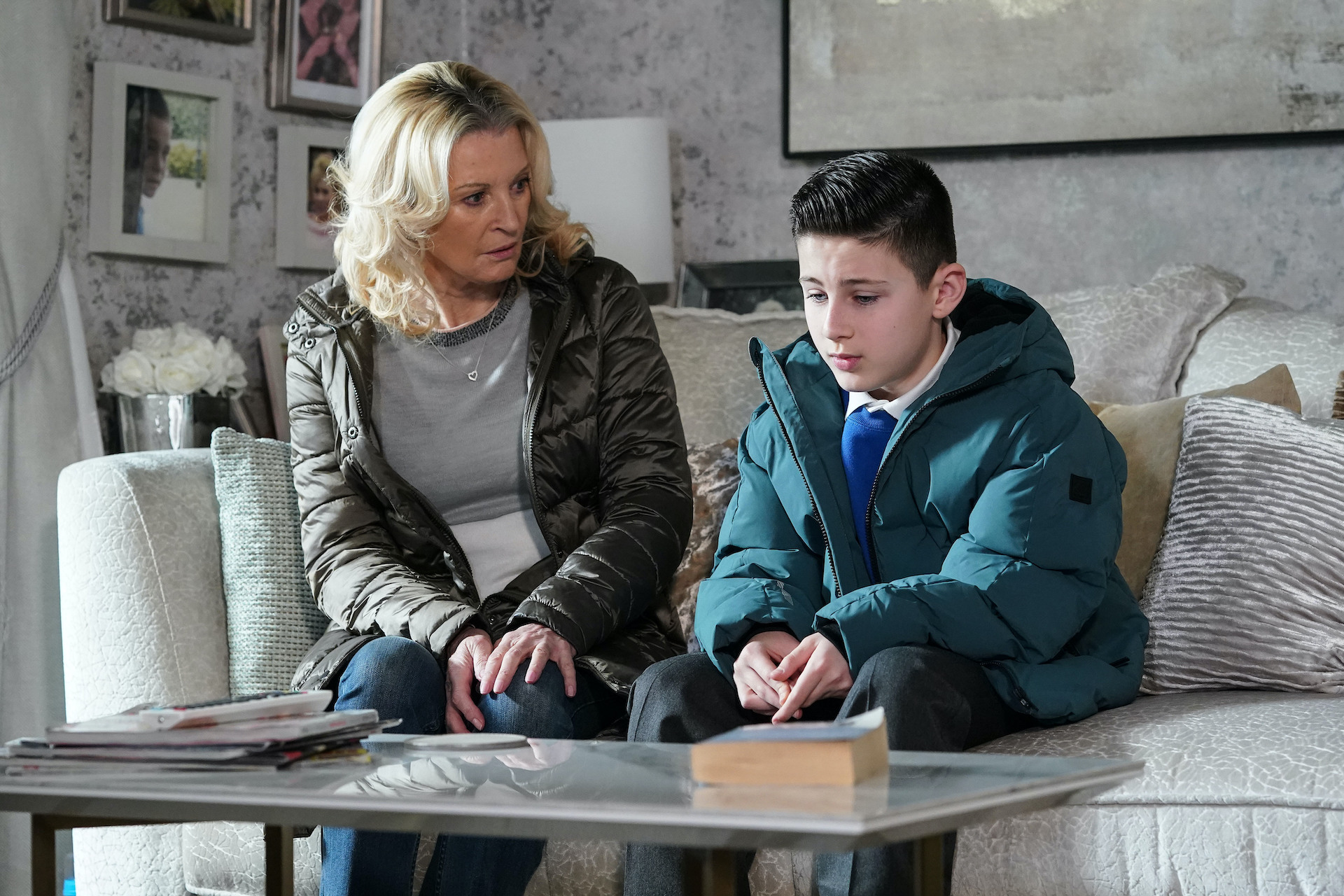 Kathy looking cross as she sits next to Louie on the sofa after he is revealed to be the blackmailer 