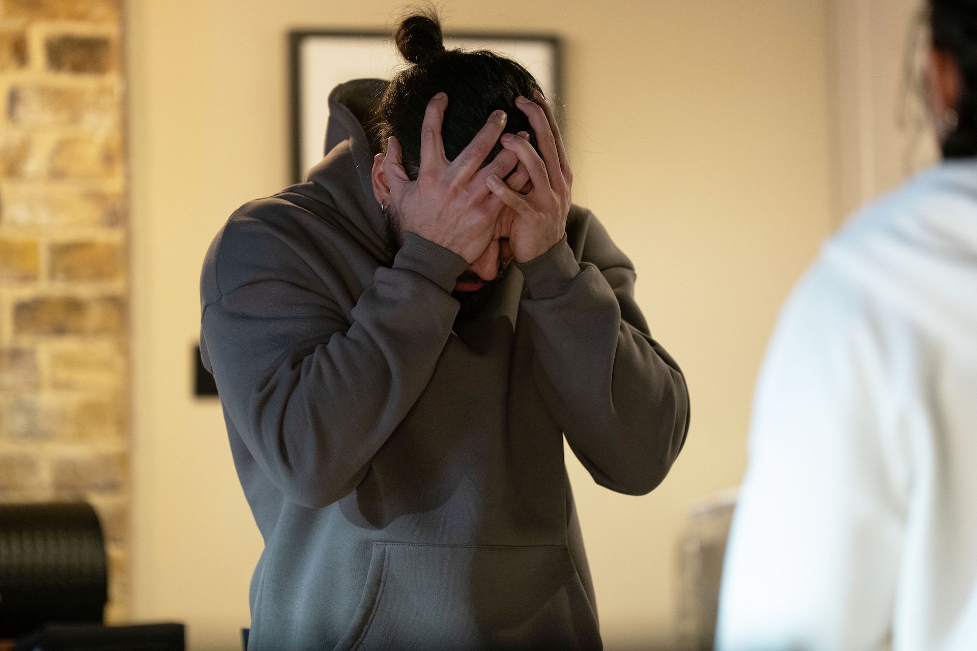 Ravi clutching his head in distress 