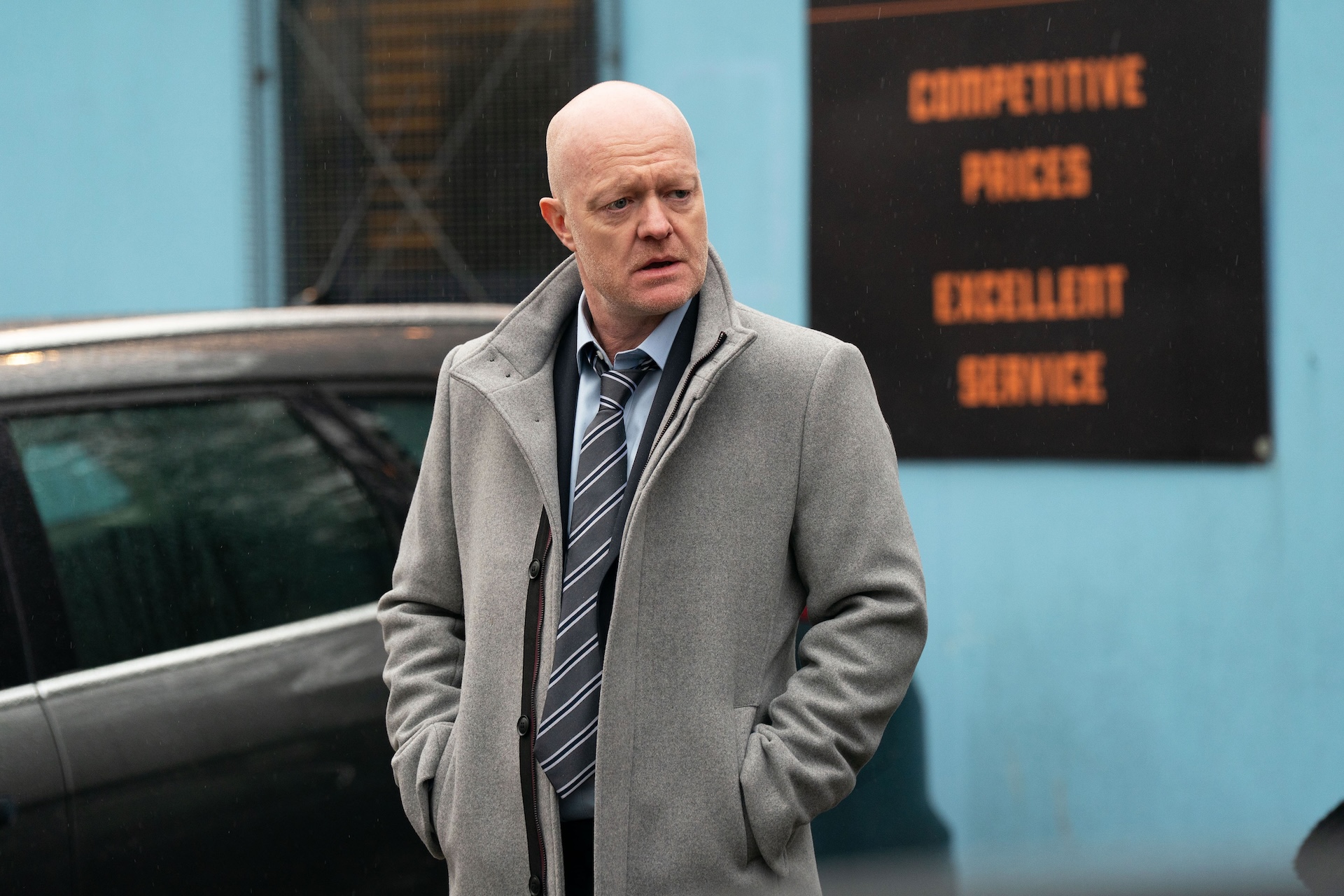 Max looking worried outside the car lot in EastEnders spoilers 