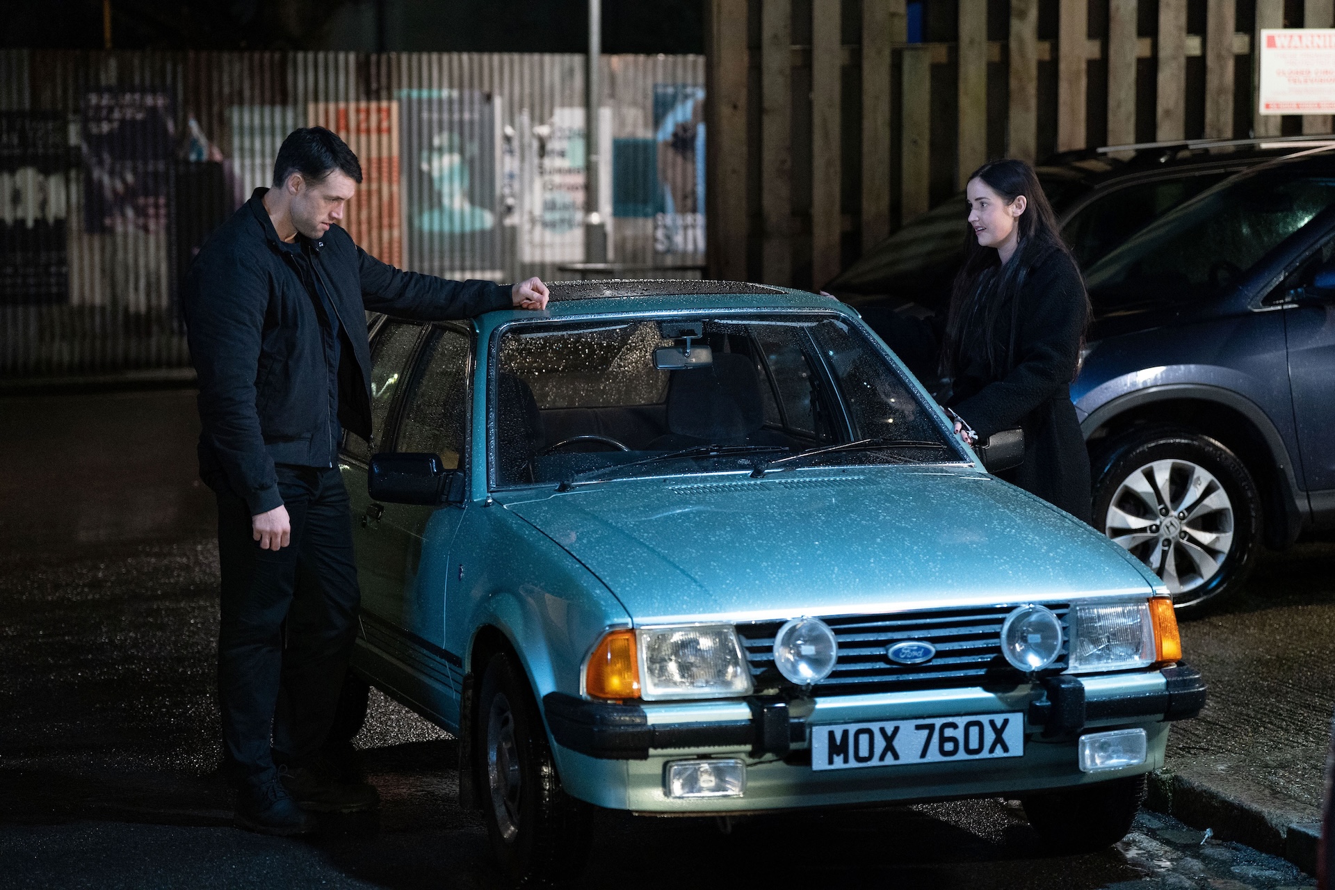 Mark and Lauren looking at an old car 