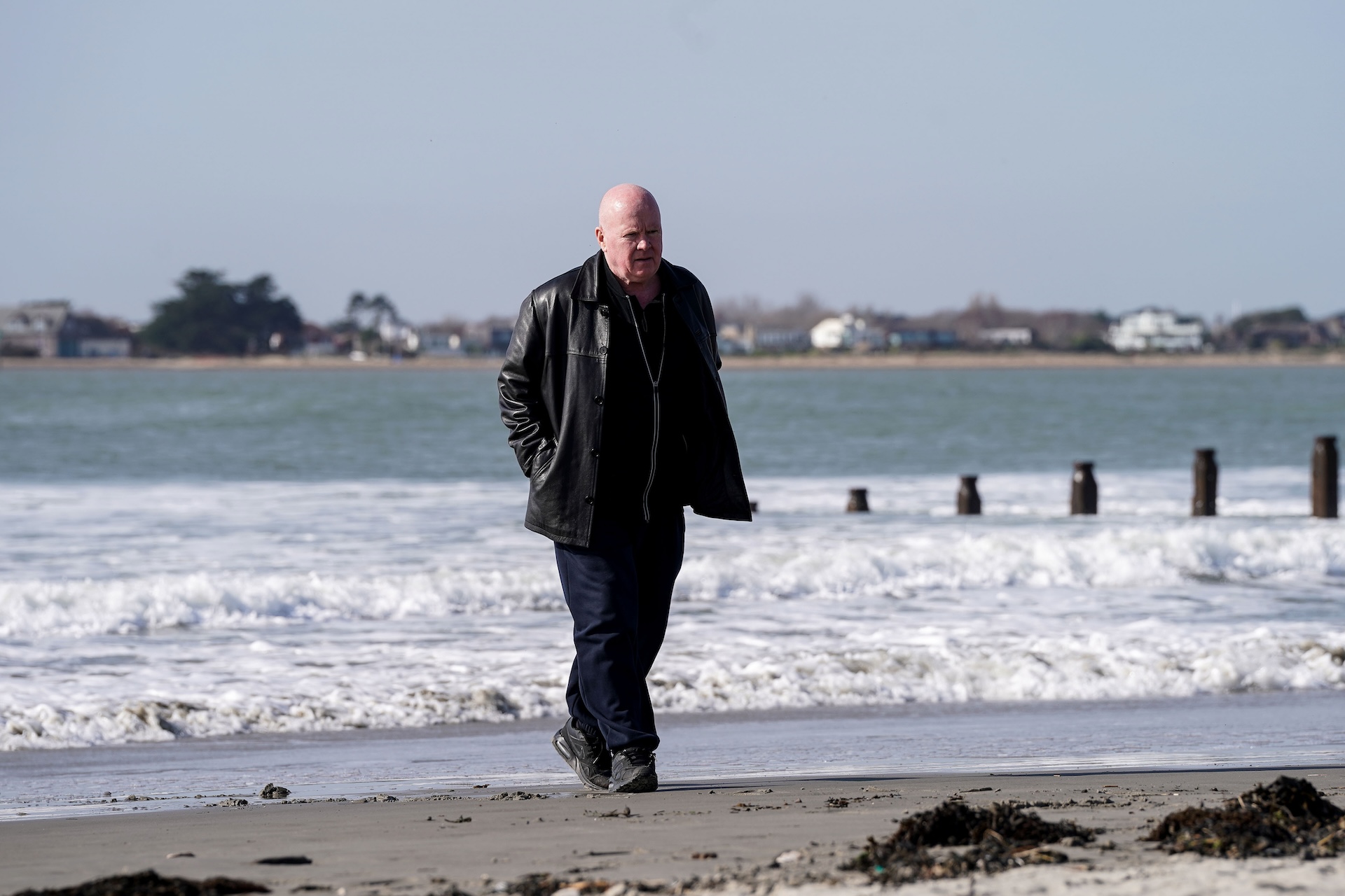 Phil walking on a beach 