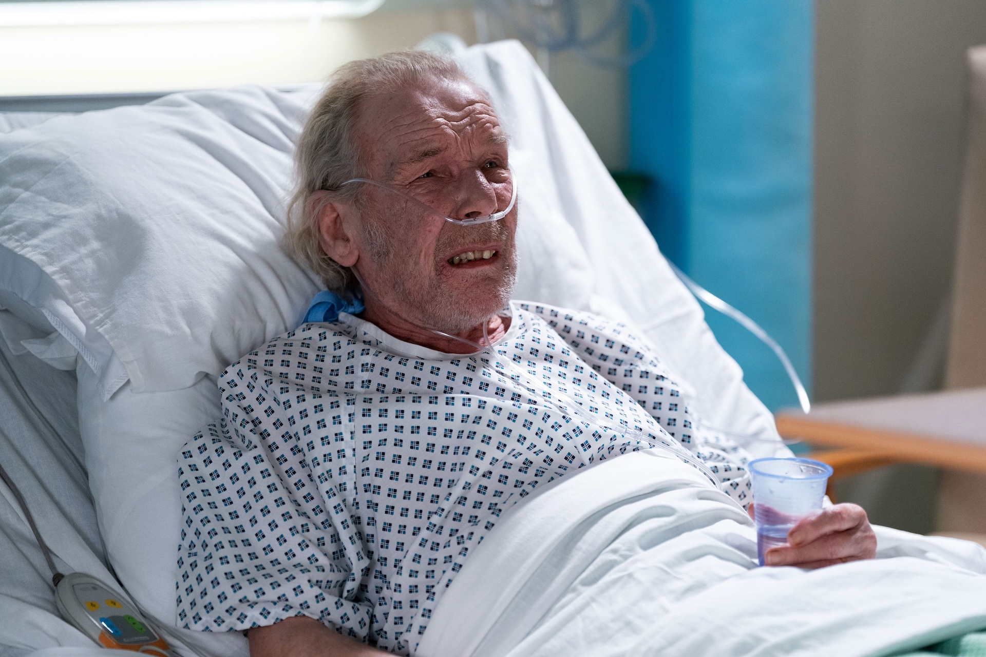 Eddie looking ill in a hospital bed 