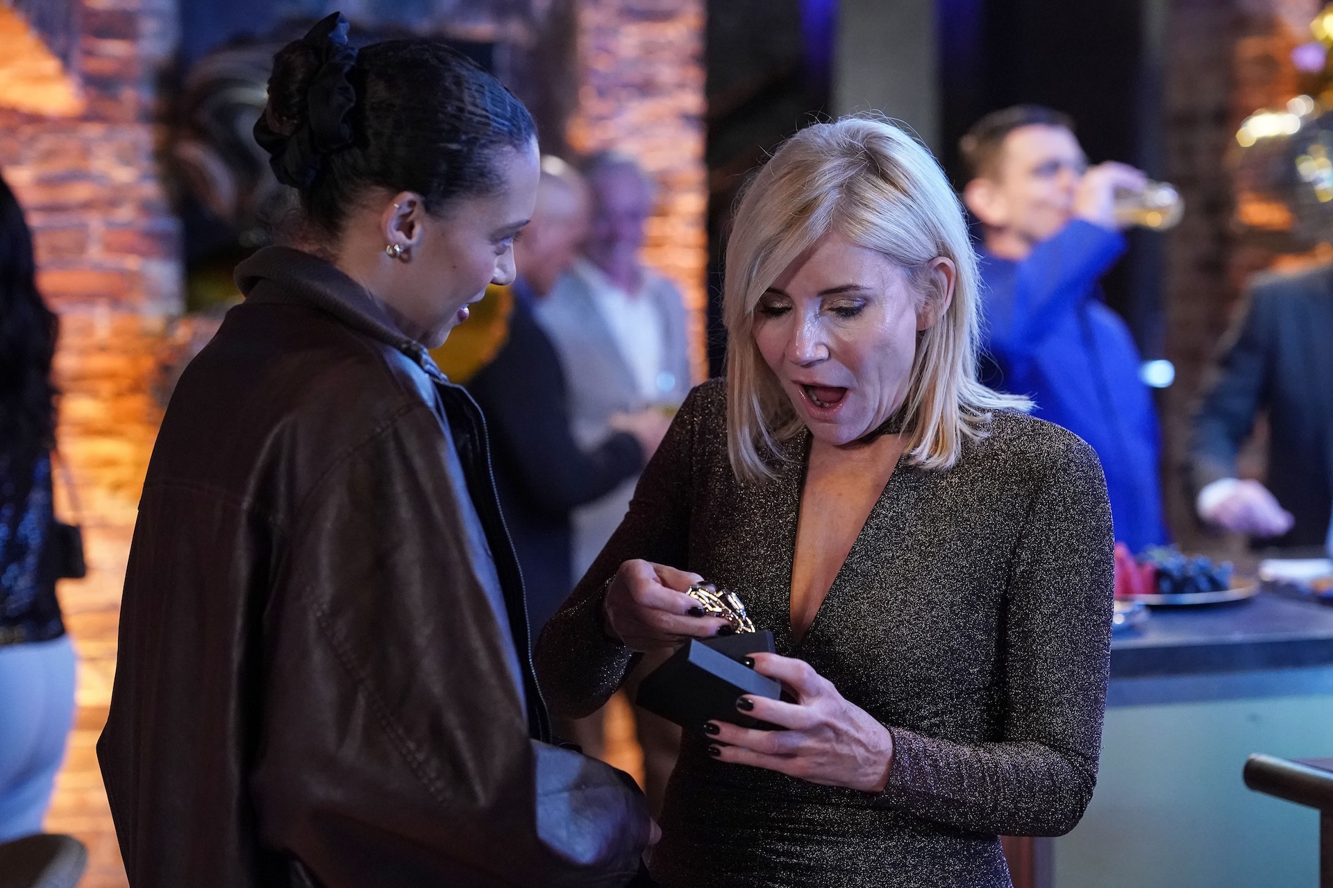 Gina giving Cindy a present and Cindy looking happy 