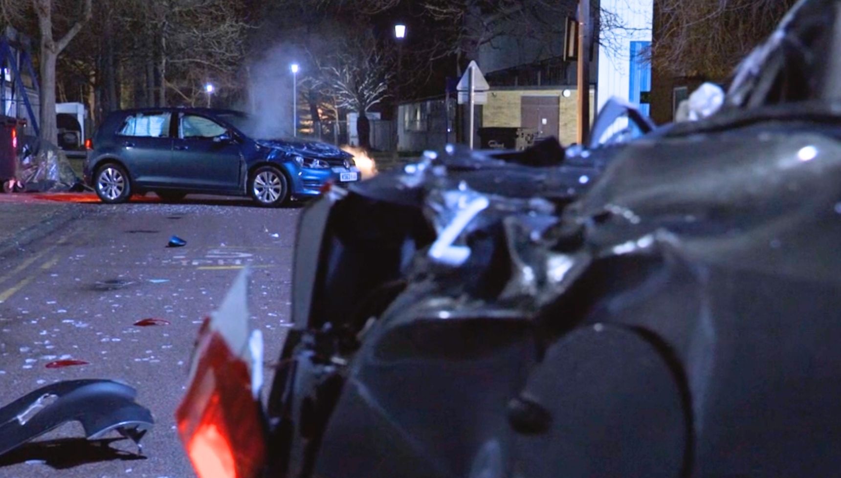 Crashed cars lying motionless on a dark road in the EastEnders crash aftermath