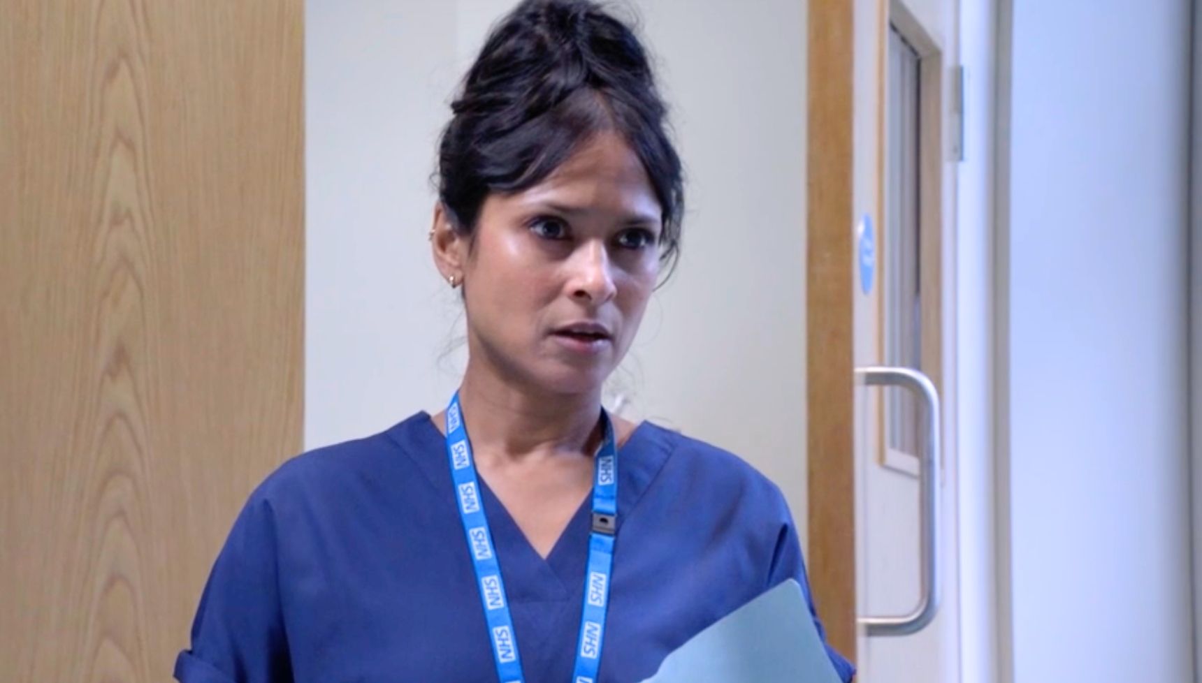 Nina in her doctors scrubs 