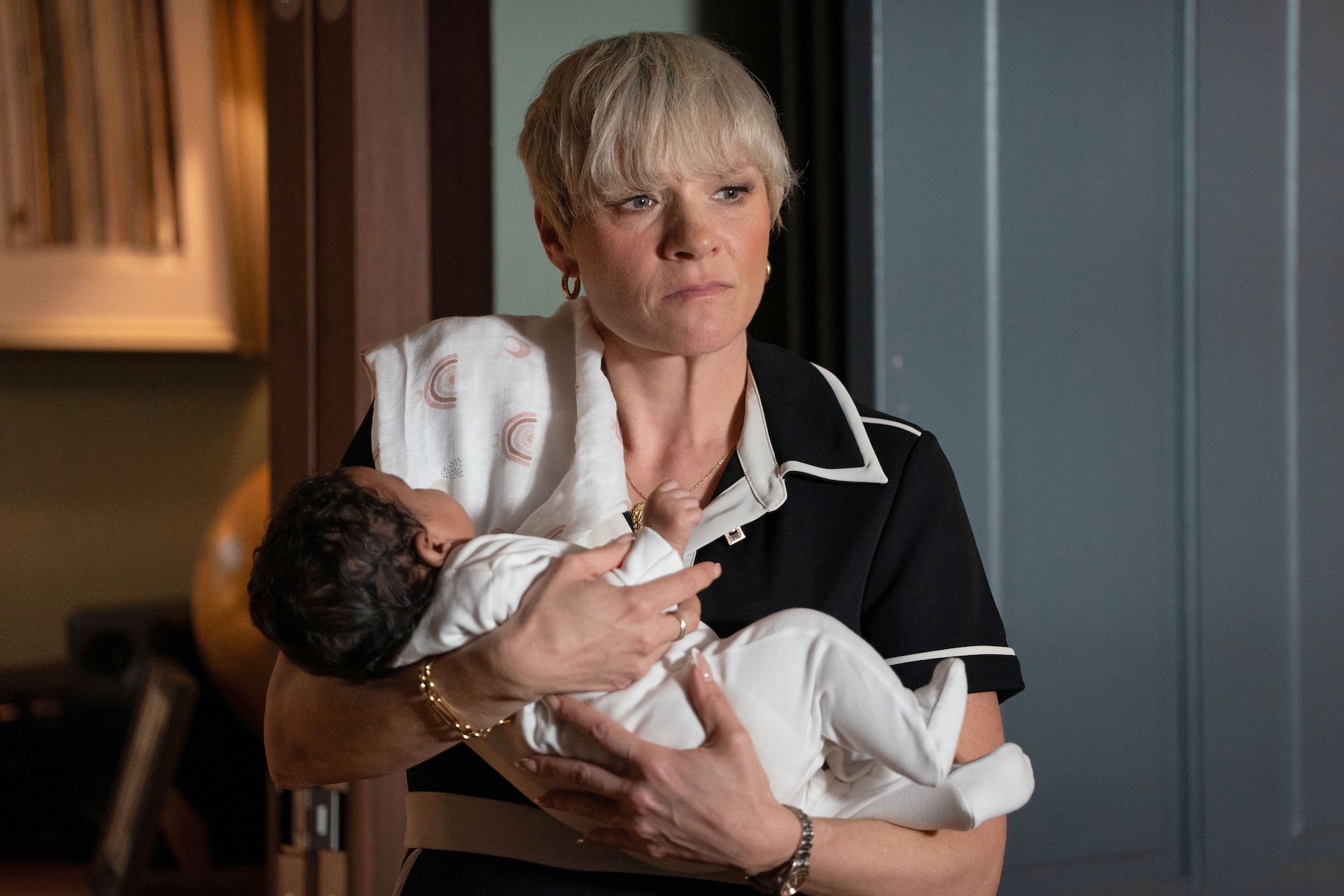 Nicola holding baby Ivy and looking stressed 