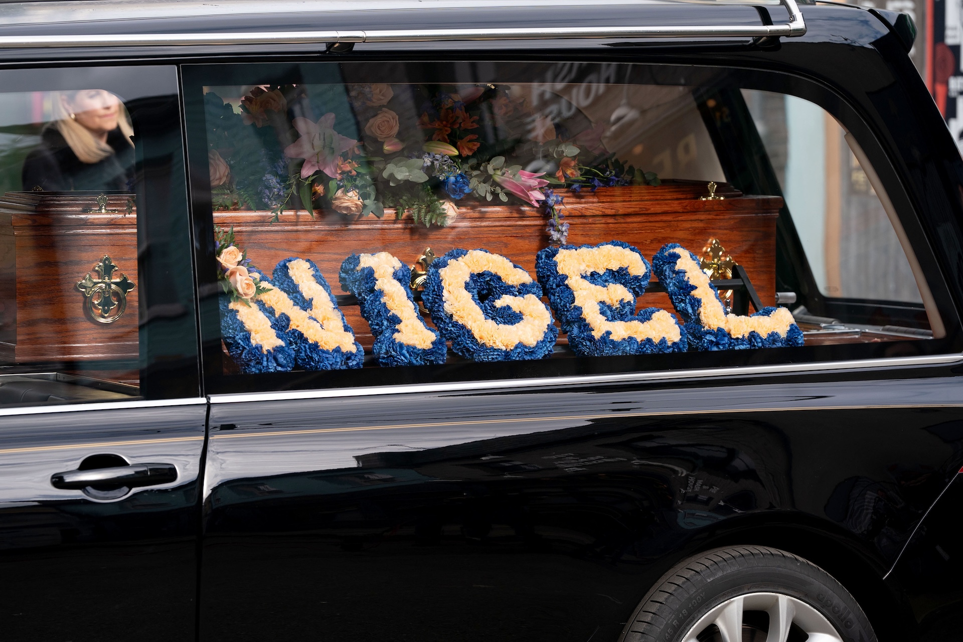 Nigel's coffin with his name in flowers in EastEnders spoilers