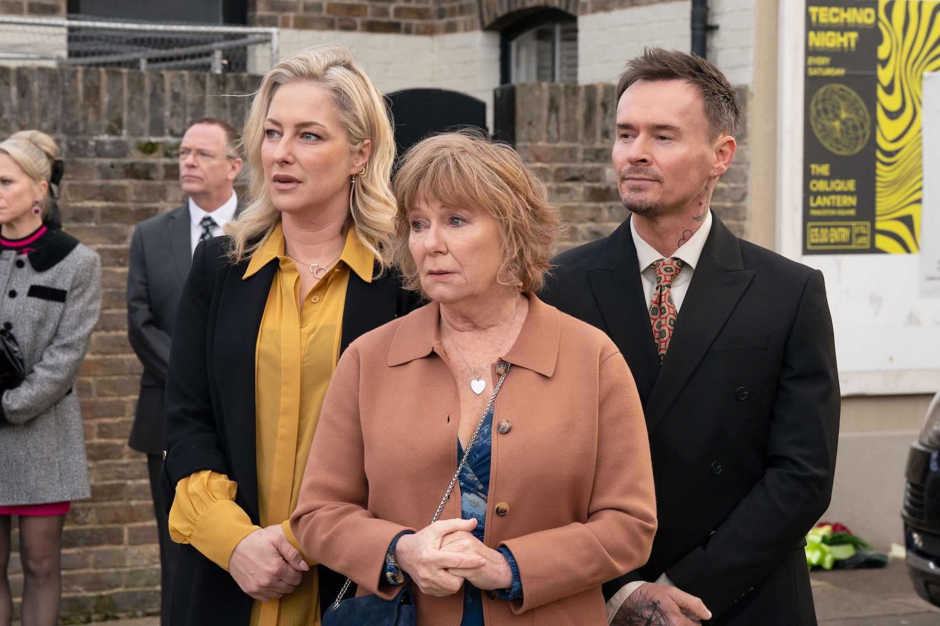 Clare and Josh stand with Julie in Albert Square 