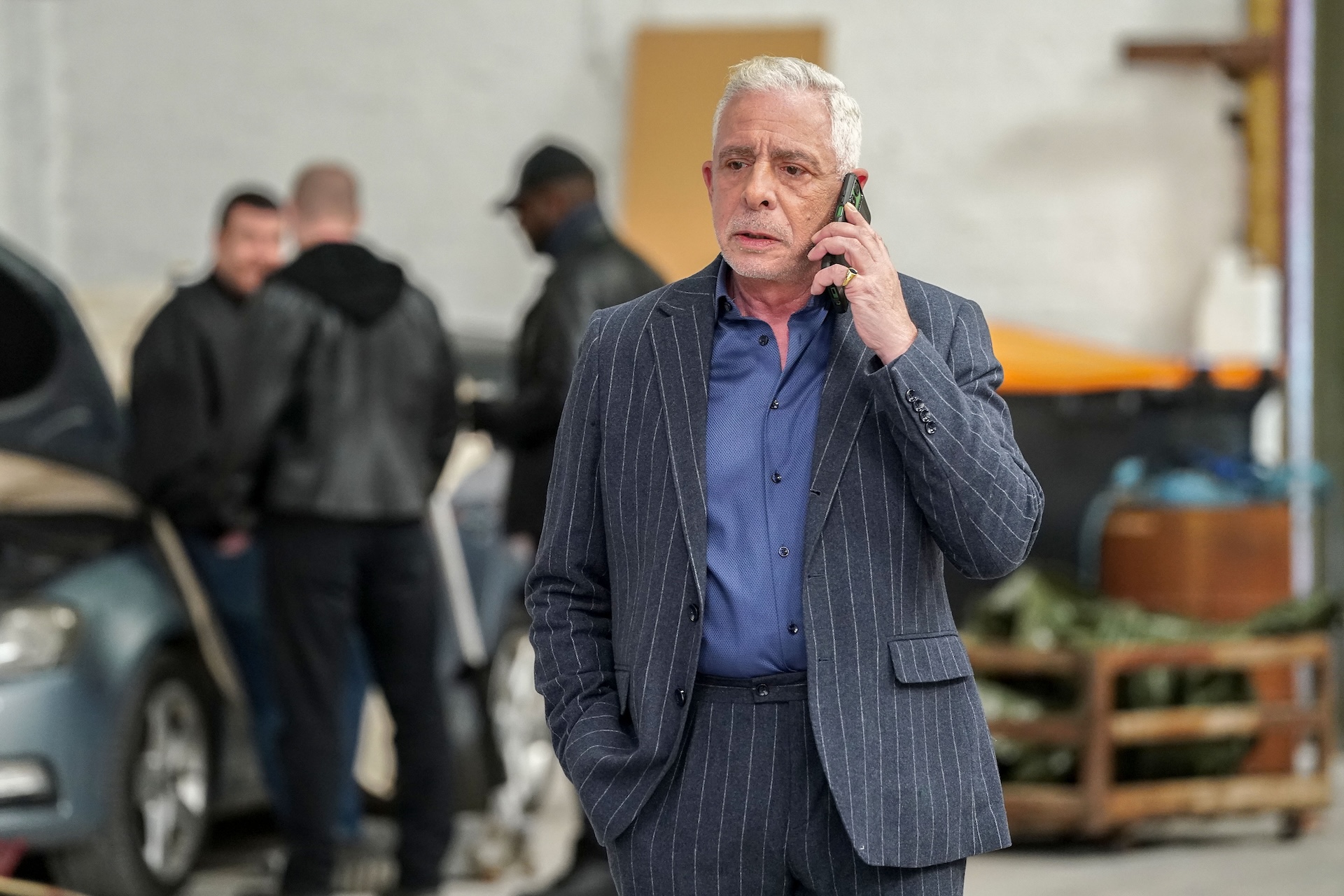 Russell on the phone looking stern 