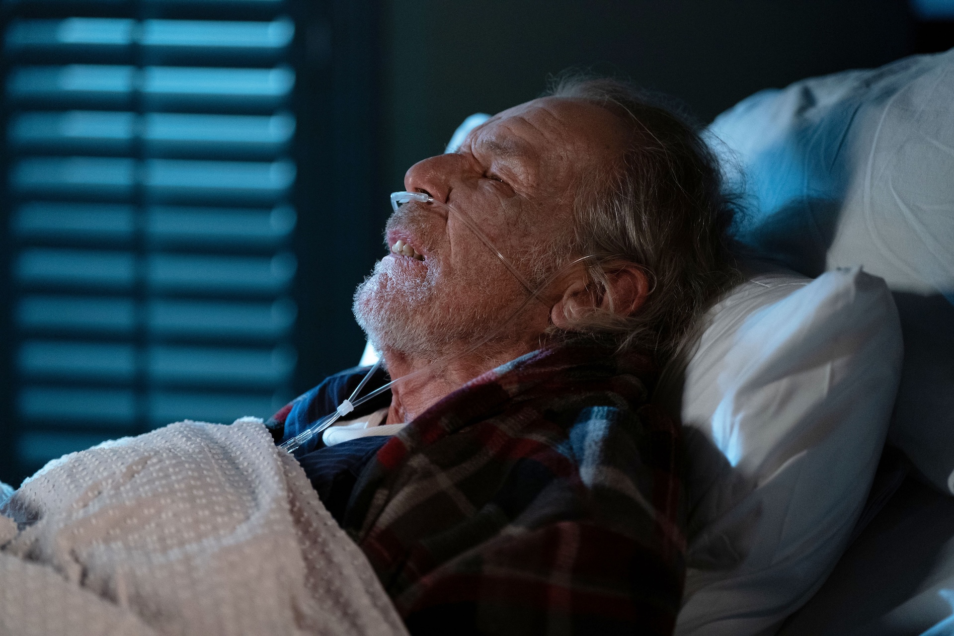 Eddie lying in bed looking gravely unwell 