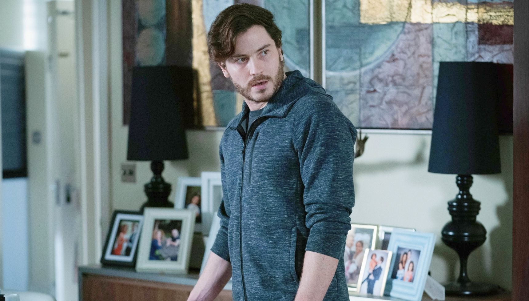 Gray looking shifty in a grey hoodie in EastEnders