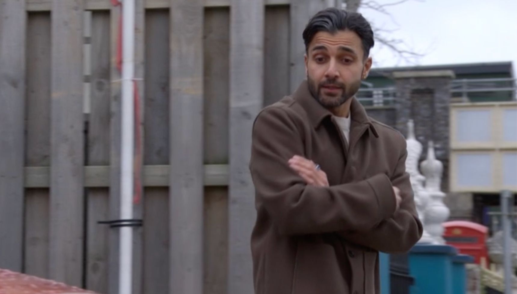 Vinny looking at a car in EastEnders