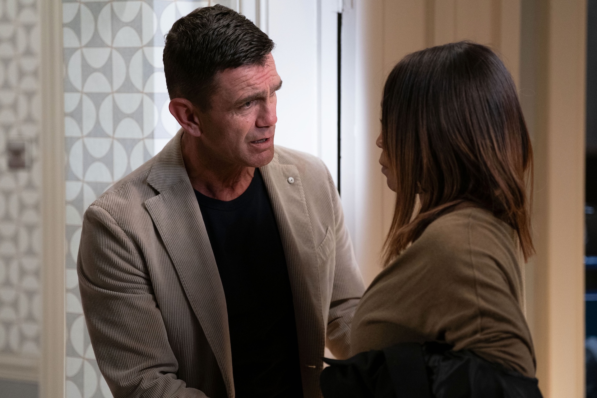 Denise and Jack talking in the hallway of their house in EastEnders 