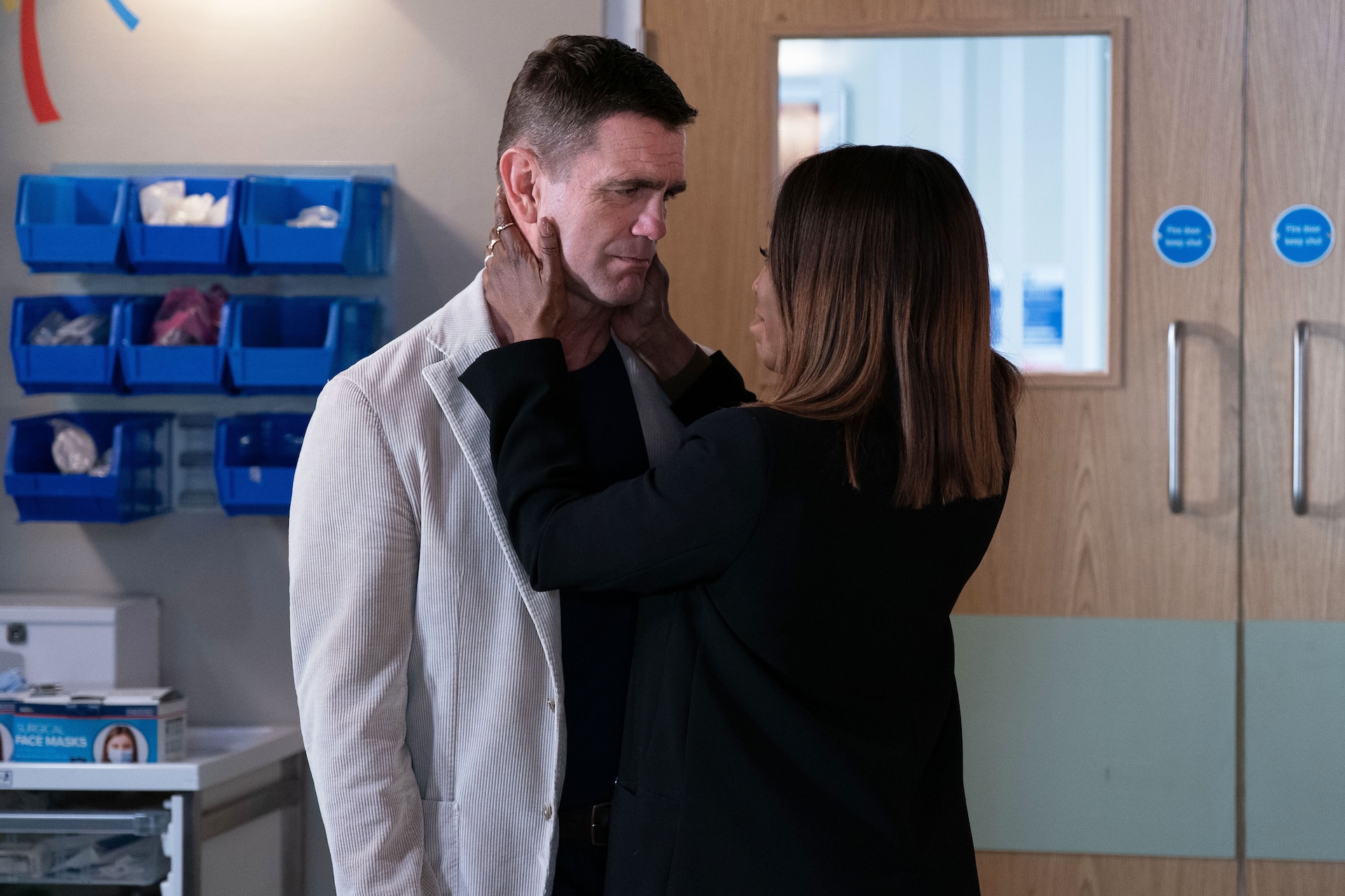 Denise holds Jack's face in her hands in the hospital corridor in EastEnders spoilers 