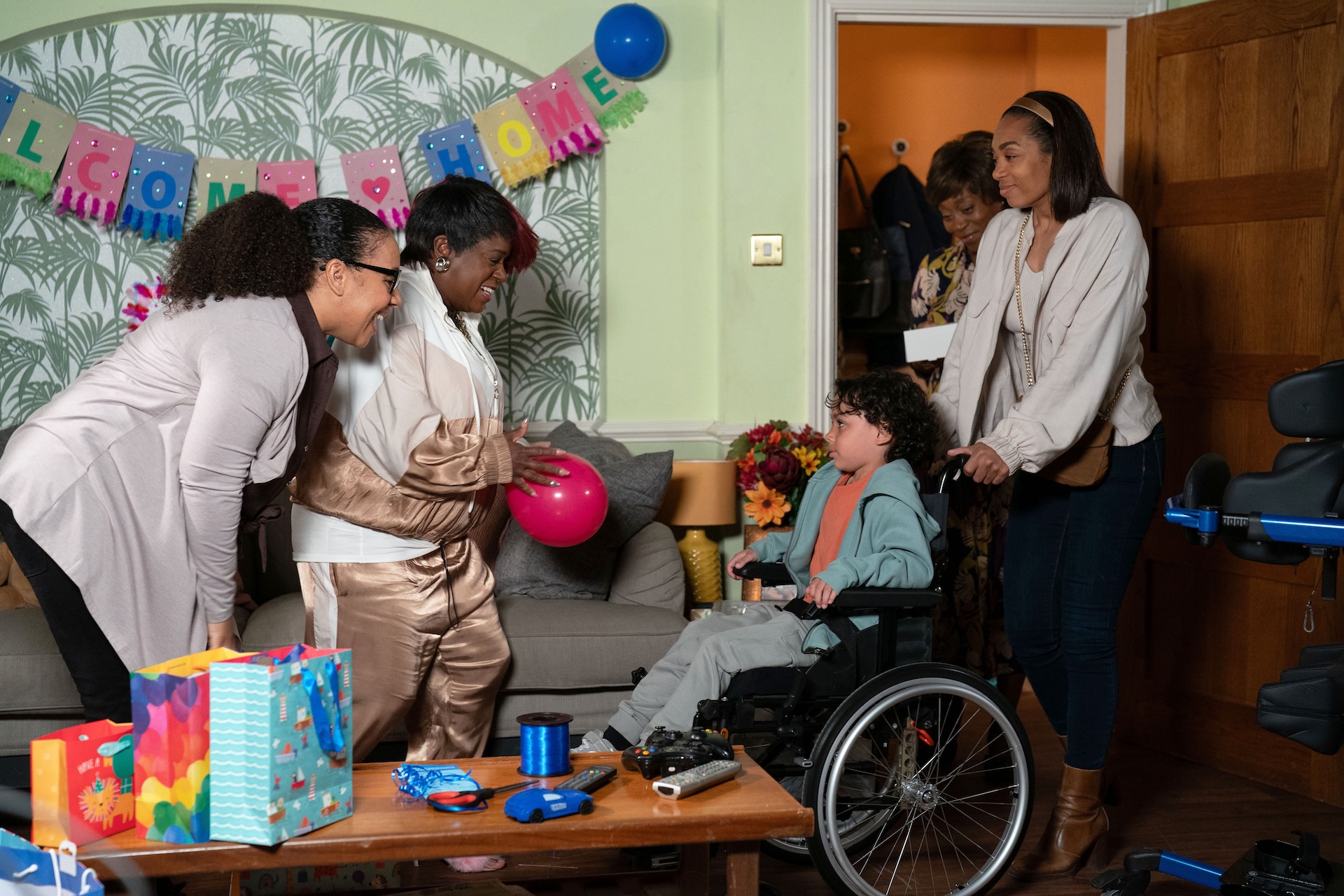 Kim and Libby welcome Jordan, who is in his new wheelchair, home 