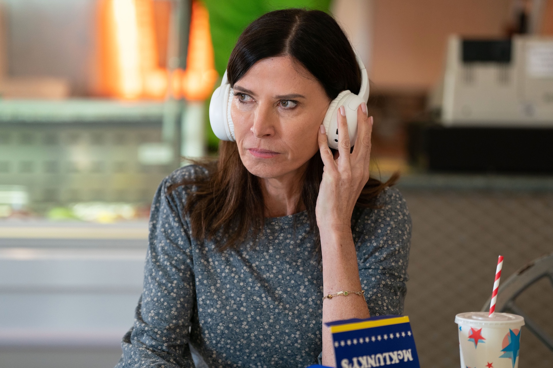 Bea with headphones on looking serious in EastEnders spoilers