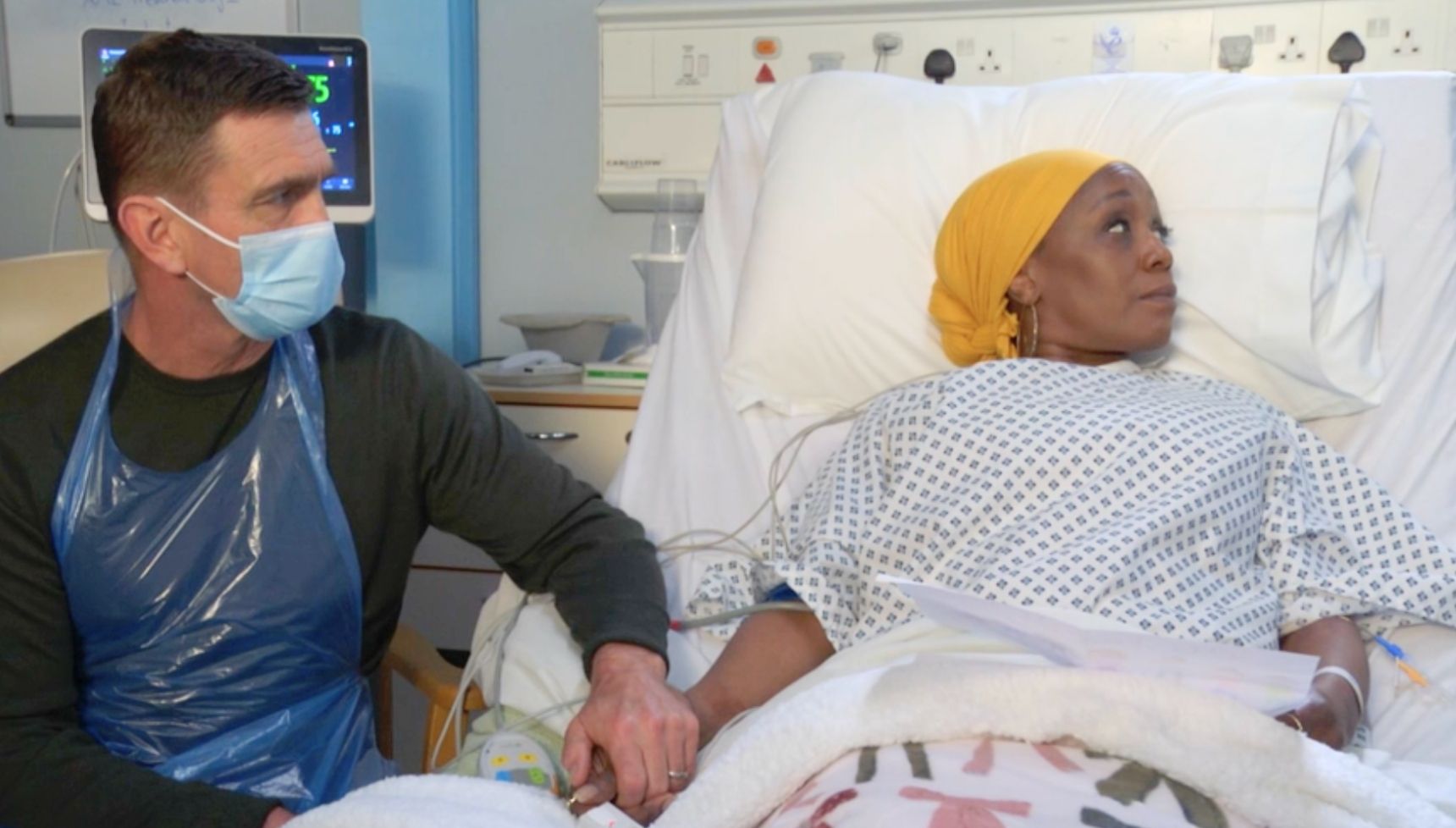 Jack holds Denise's hands as she goes into hospital