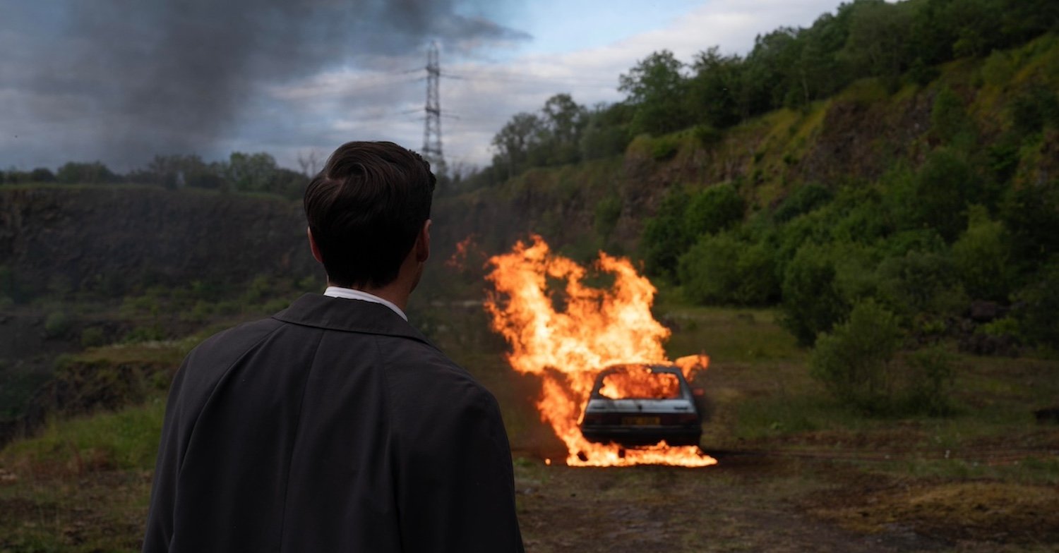 Karen Pirie S2 DI Anderson (Thoren Ferguson) watches as Cat’s Vauxhall goes up in flames