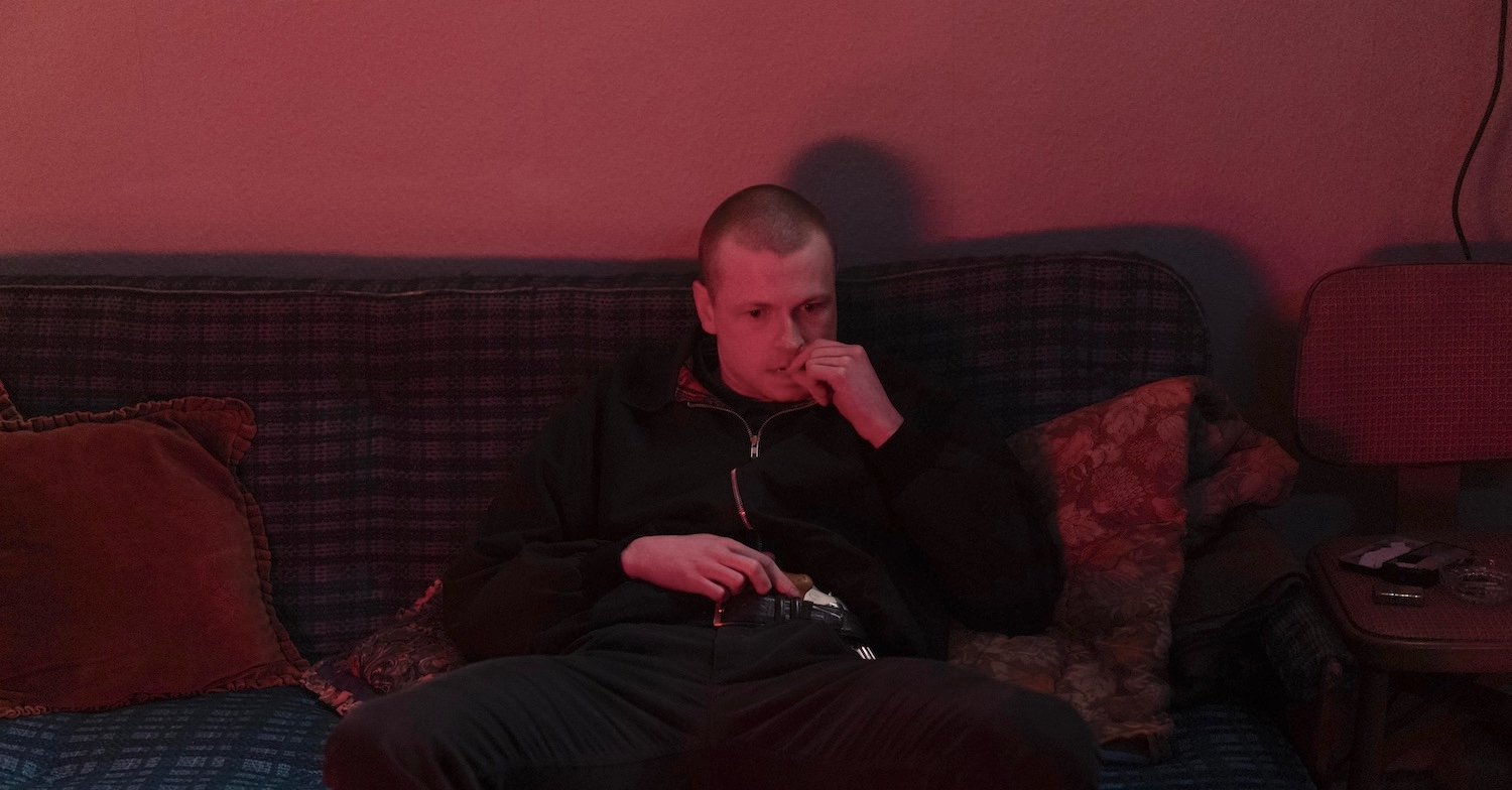Stuart Campbell as Kevin Campbell, sitting on a sofa in the kidnap cottage, in Karen Pirie series two
