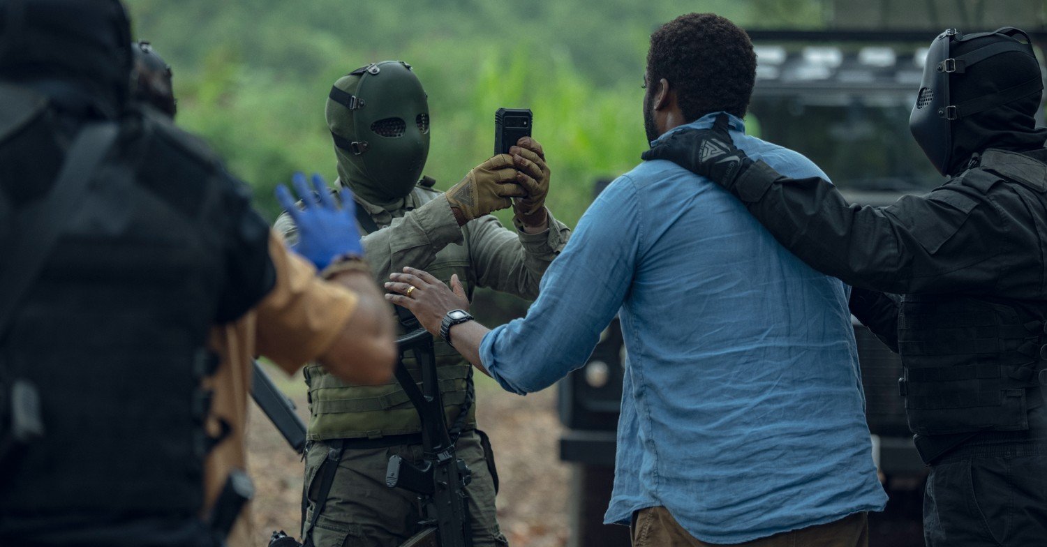 Masked men taking picture of hostage on Netflix