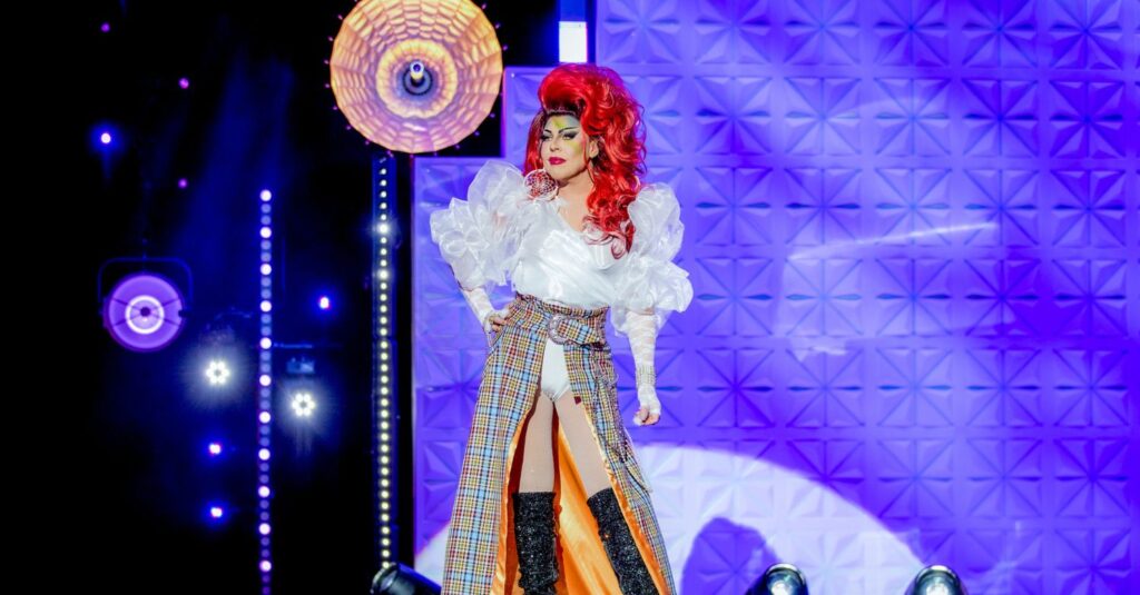 La Voix on stage in drag